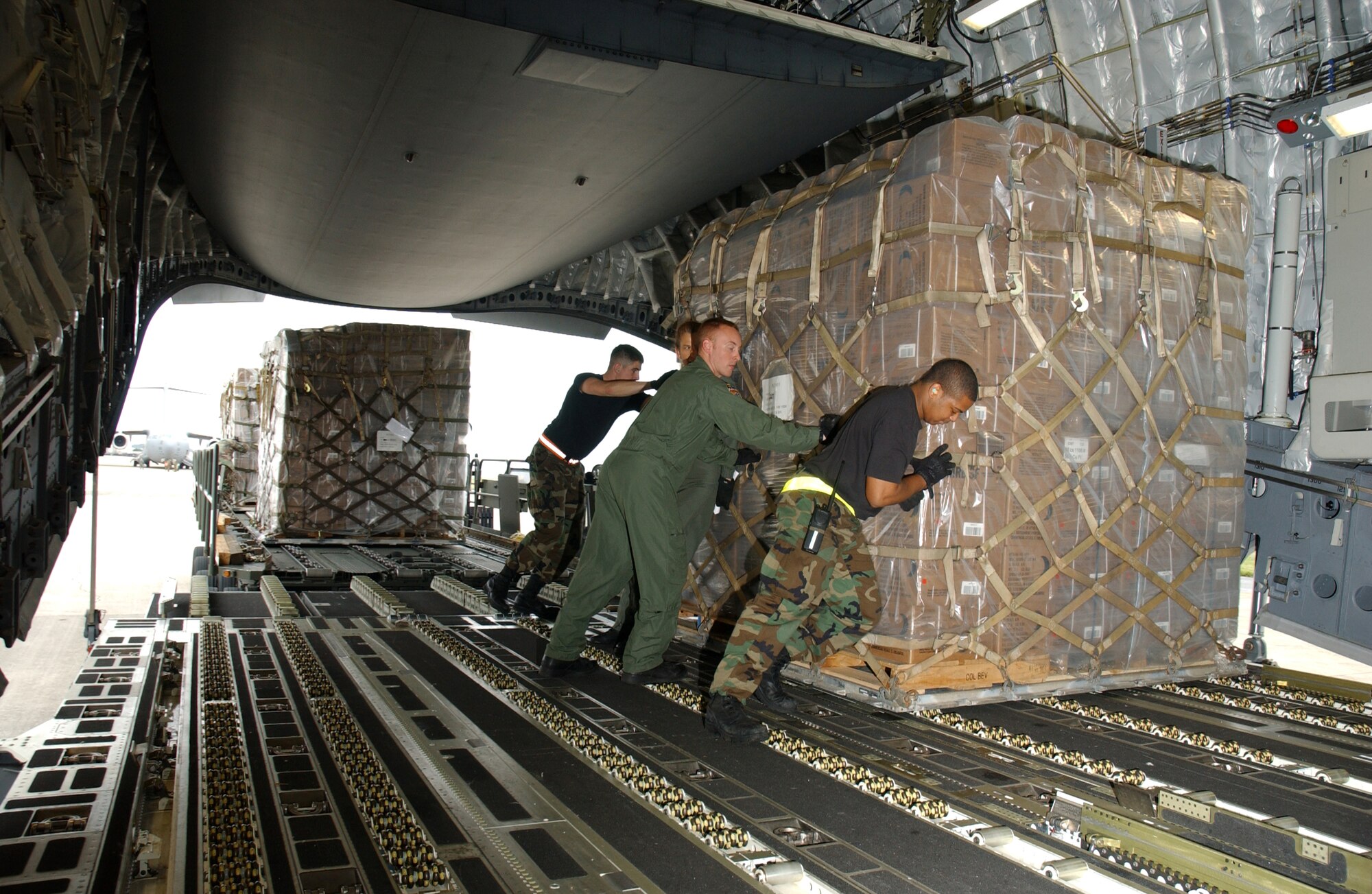 KADENA AIR BASE, Okinawa - Airmen from the 733rd Air Mobility Squadron here at Kadena and 15th Airlift Wing at Hickam Air Force Base, Hawaii, load food, cold weather gear and medical supplies onto a C-17 Globemaster III Feb. 8 bound for China. Recently, 19 Chinese provinces experienced the most severe winter storms in 50 years, imposing severe hardships on millions of Chinese citizens. U.S. Pacific Command coordinated the delivery of the humanitarian supplies to People’s Liberation Army at Shanghai International Airport, China. (U.S. Air Force Photo/Senior Airman Jeremy McGuffin)  