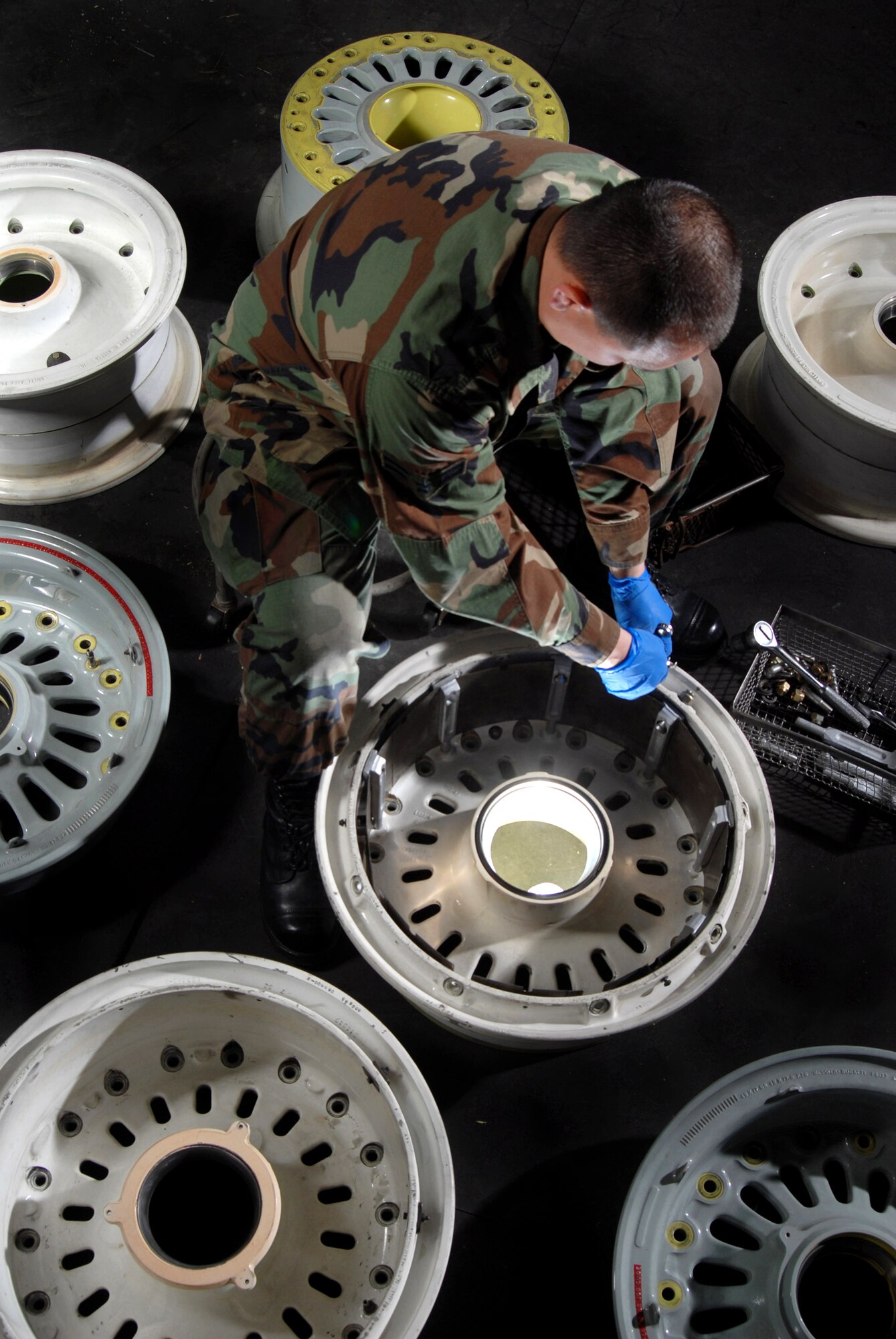 Airman 1st Class Jonathan Centers, an aircraft mechanic from the Aero Repair Shop at March Air Reserve Base, Calif., uses a ratchet wrench Feb. 3 to install a heat shield on a KC-135 Stratotanker refueling aircraft main wheel.  March ARB, located in Southern California, is home to the largest air mobility wing in the Air Force Reserve Command. It also is home to units from the Army Reserve, Navy Reserve, Marine Corps Reserve and Air National Guard. (U.S. Air Force photo/Val Gempis)
