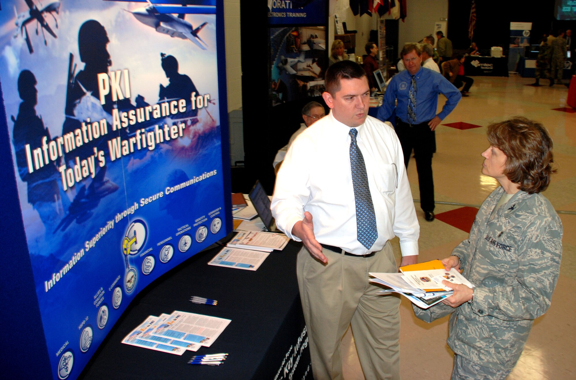 Jerrod Loyless, a public information key systems engineer with General Dynamics, talks to Col. Nancy Dezell, 882nd Training Group commander, about the benefits of using a PKI system Feb. 7 at the Sheppard Tech Expo. The tech expo gives Team Sheppard members a chance to view the latest training technology and to learn how to integrate the technology into their classrooms. (U.S. Air Force photo/Airman 1st Class Jacob Corbin)