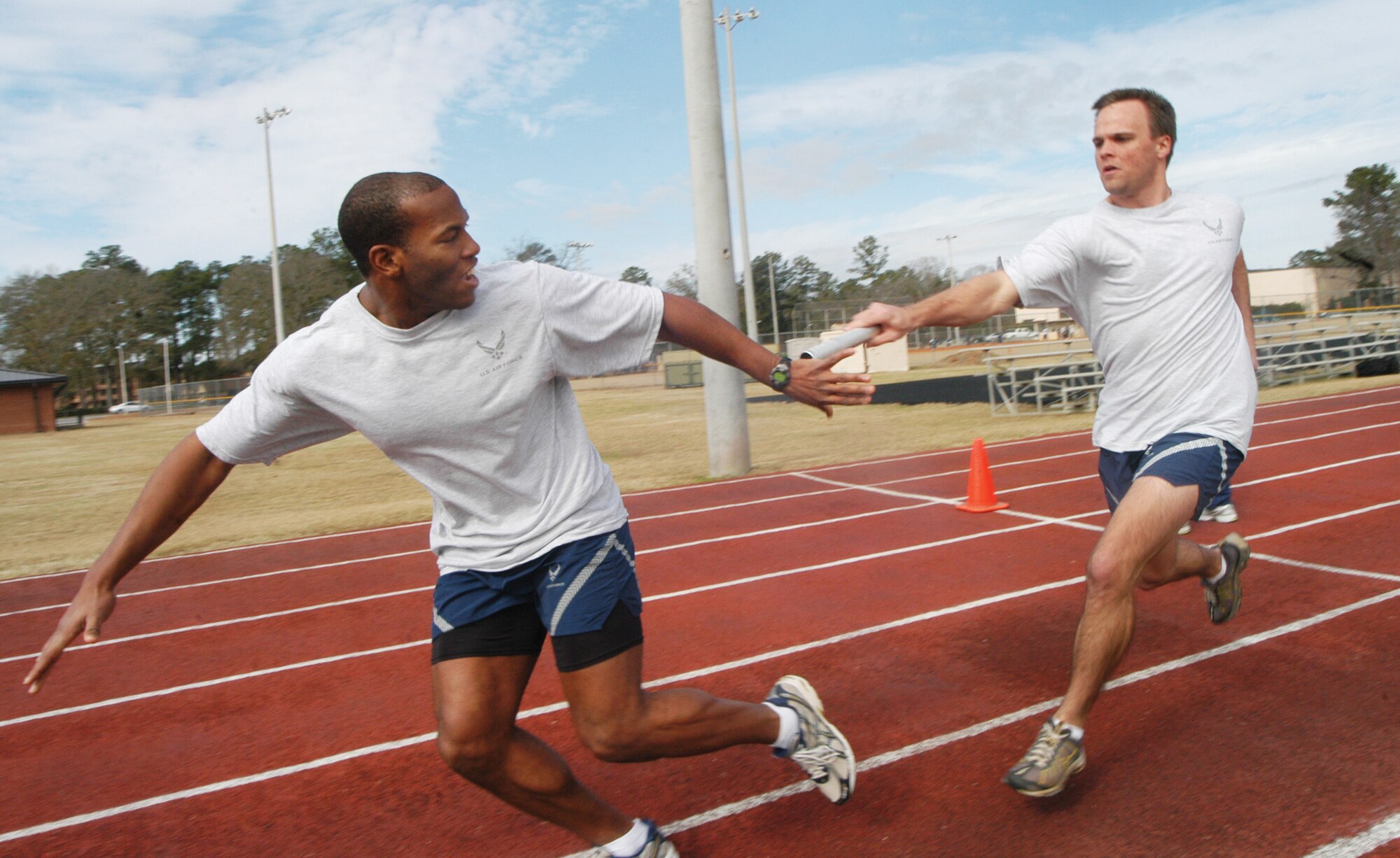 1st Lt. Sherrod Brown takes the baton from 2nd Lt. Michael Webber for the 78th Medical Group in the 4 X 1 relay. U. S. Air Force photo by Sue Sapp   