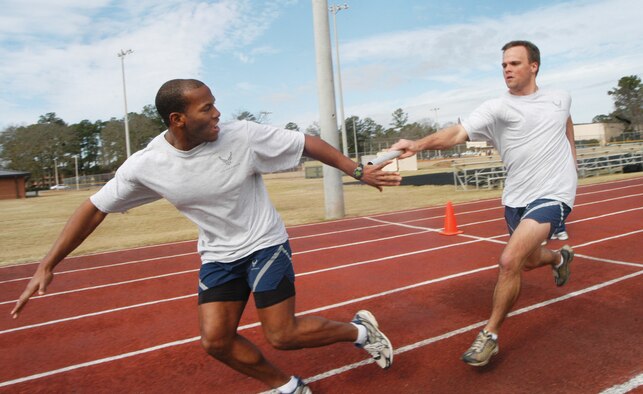 1st Lt. Sherrod Brown takes the baton from 2nd Lt. Michael Webber for the 78th Medical Group in the 4 X 1 relay. U. S. Air Force photo by Sue Sapp   