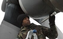 YOUNGSTOWN AIR RESERVE STATION, Ohio - Air Force Reserve Senior Airman Justin C. Johnson uses a flashlight to peer into the interior of an C-130 engine intake while conducting a thru-flight inspection of an aircraft on the flight line here. The inspection is part of his crew chief duties while on Annual Tour during the week of Feb. 4 through 8. The scheduled work being conducted on the aircraft occurs between every flight to ensure no damage, including cracks to the intakes and exhaust ports of the engines, has occured during the cargo transport aircraft's flight operations. Senior Airman Johnson is a Traditional Reservist assigned to the 910th Maintenance Squadron. He is currently working on his 5-Level Skills Training. U.S. Air Force photo by Tech. Sgt. Bob Barko Jr.  
