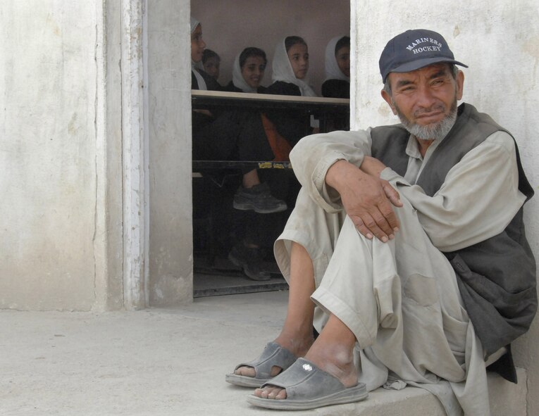 The school’s janitor sits outside a classroom in a Kabul school. International Security Assistance Force troops visited the school Aug. 5, 2007, to deliver school supplies. (ISAF photo by Master Sgt. Russell P. Petcoff)