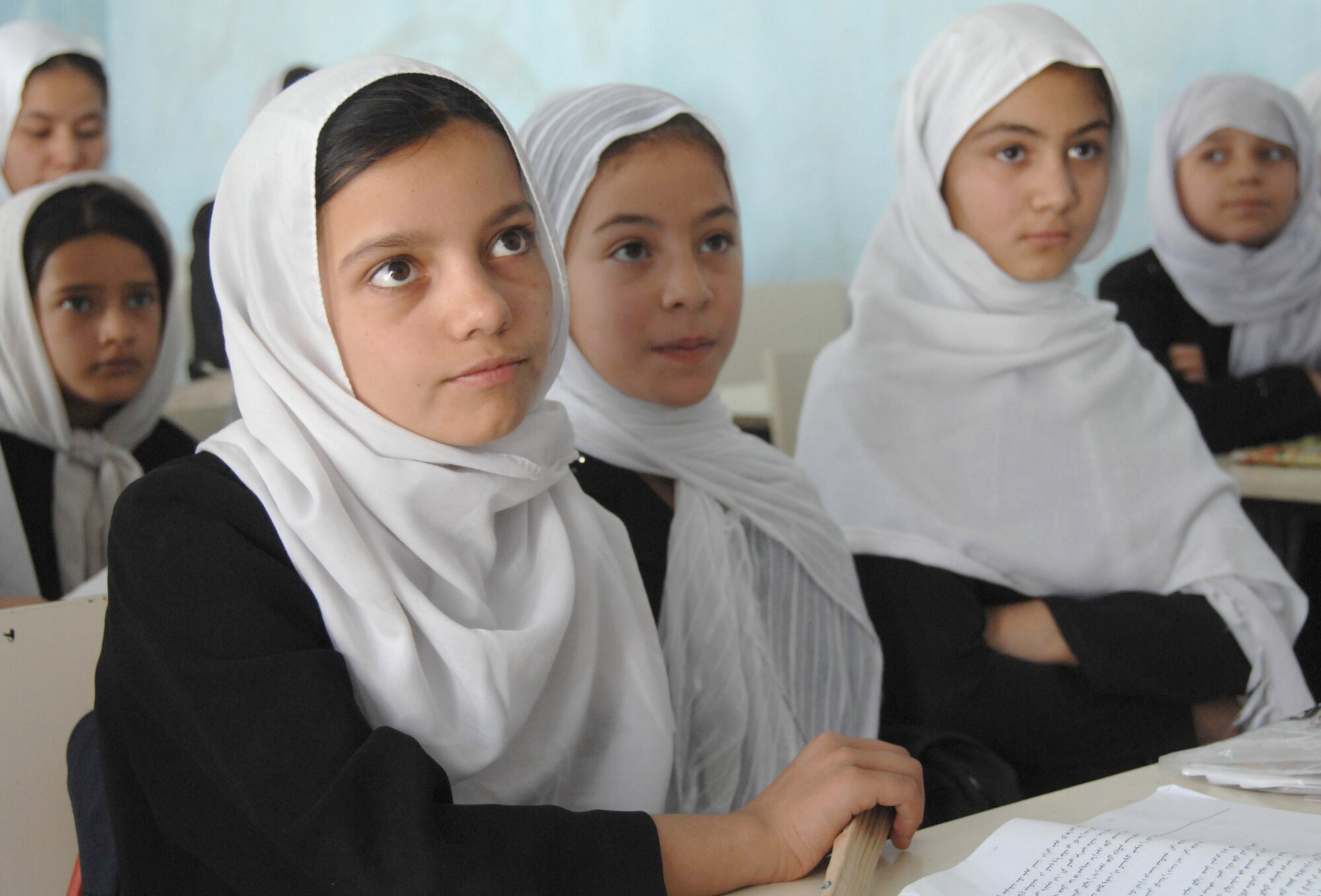 Female Afghan students listen in their Kabul classroom. International Security Assistance Force troops visited the school Aug. 5, 2007, to deliver school supplies. (ISAF photo by Master Sgt. Russell P. Petcoff)