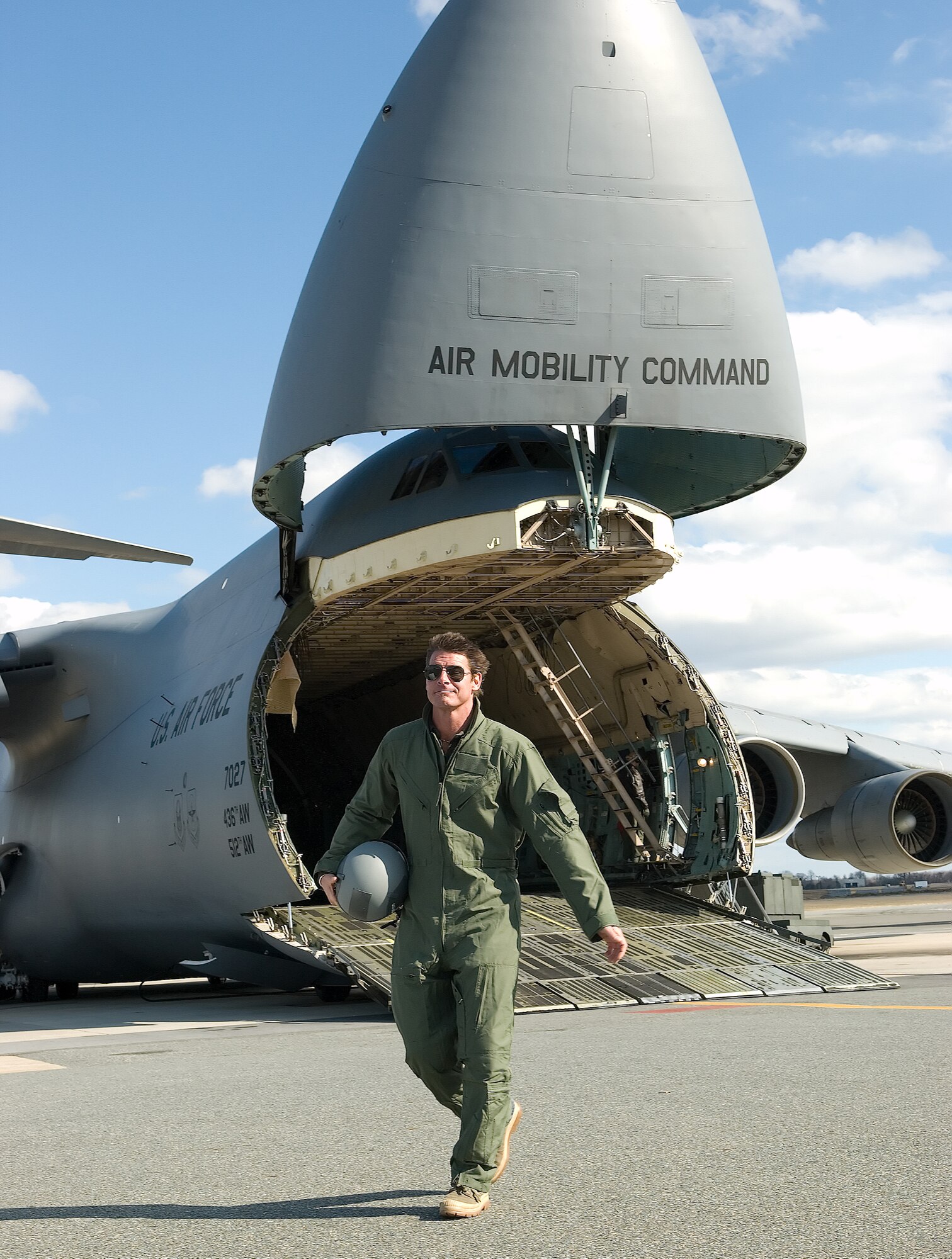 Ty Pennington, host of "Extreme Makeover: Home Edition," walks past a C-5 Galaxy during the filming of an introduction to the show Feb. 7 at Dover Air Force Base, Del. The episode is scheduled to air March 30. (U.S. Air Force photo/Jason Minto) 