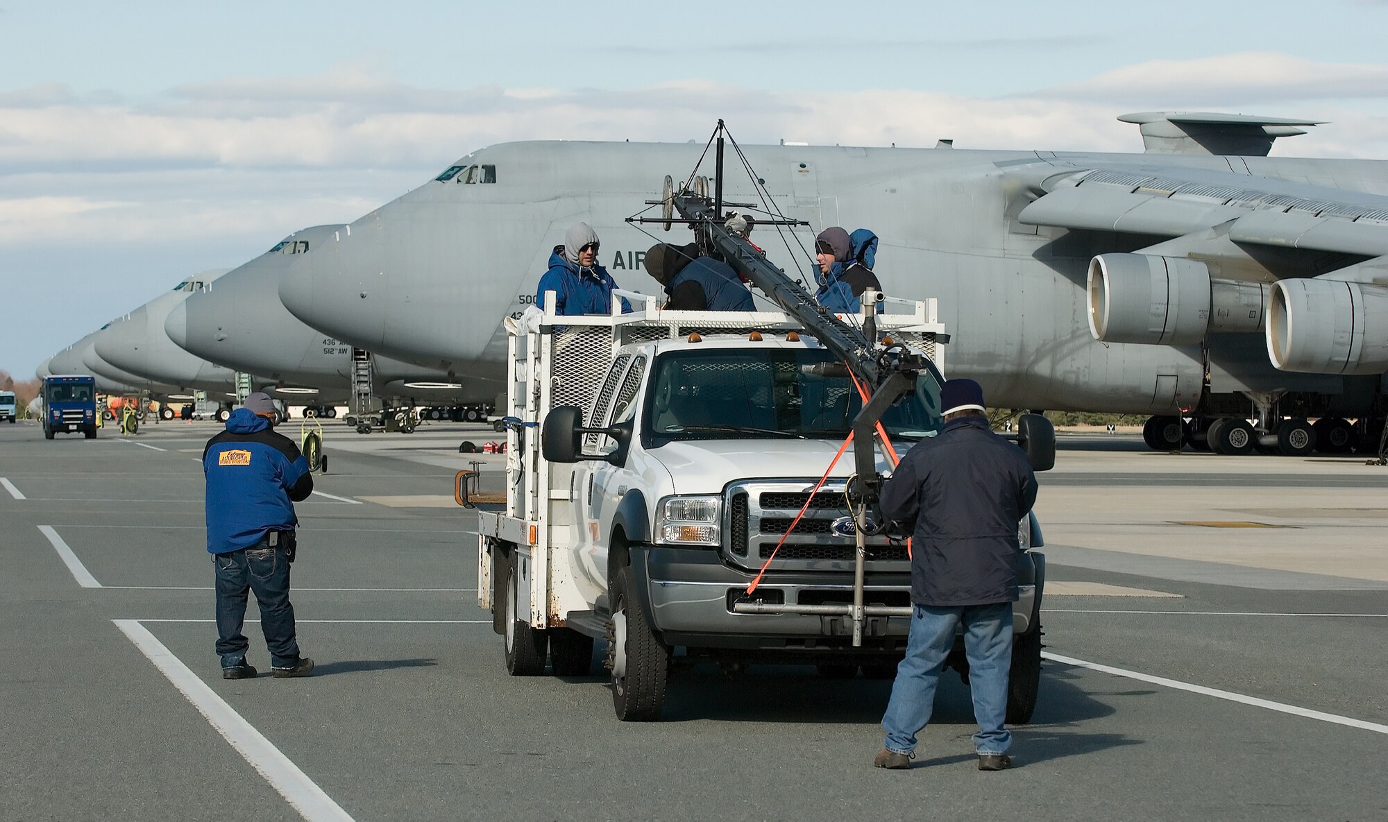 An "Extreme Makeover: Home Edition" film crew readies their camera equipment for a Feb. 7 shot on the flightline at Dover Air Force Base, Del. The crew visited Dover AFB to film the introduction for an upcoming episode, scheduled to air March 30. (U.S. Air Force photo/Jason Minto) 

