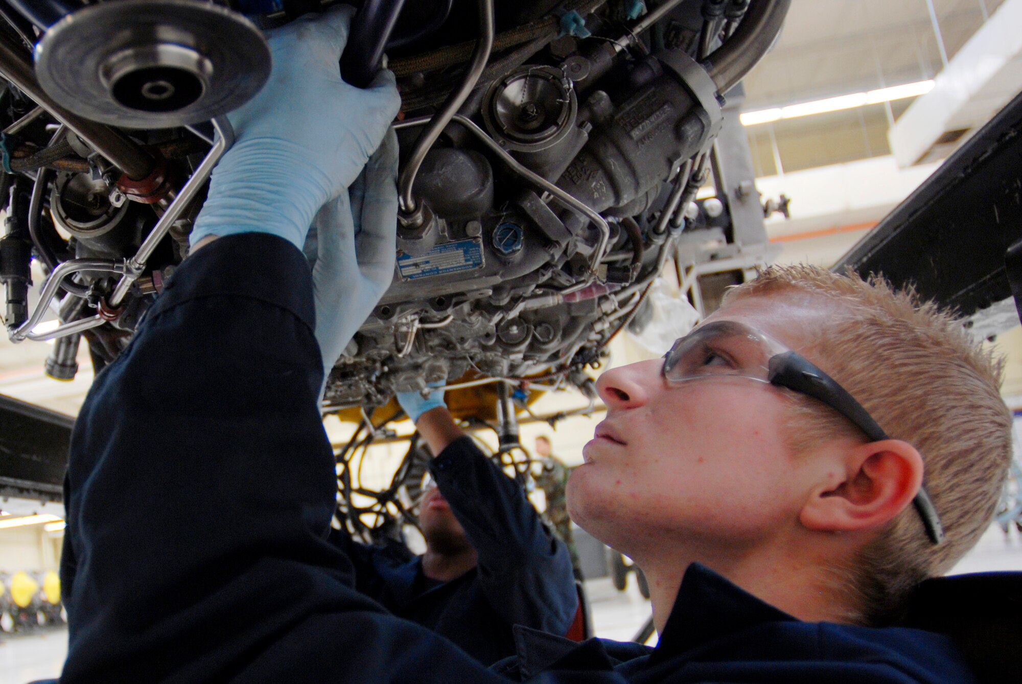 Airman First Class Lance Leisen, 56th Component Maintenance Squadron aerospace propulsion apprentice, clamps short tubes to prevent chafing. If not clamped properly, chafing could cause a fuel leak during flight. (photo by Staff Sgt. Christopher Hummel)