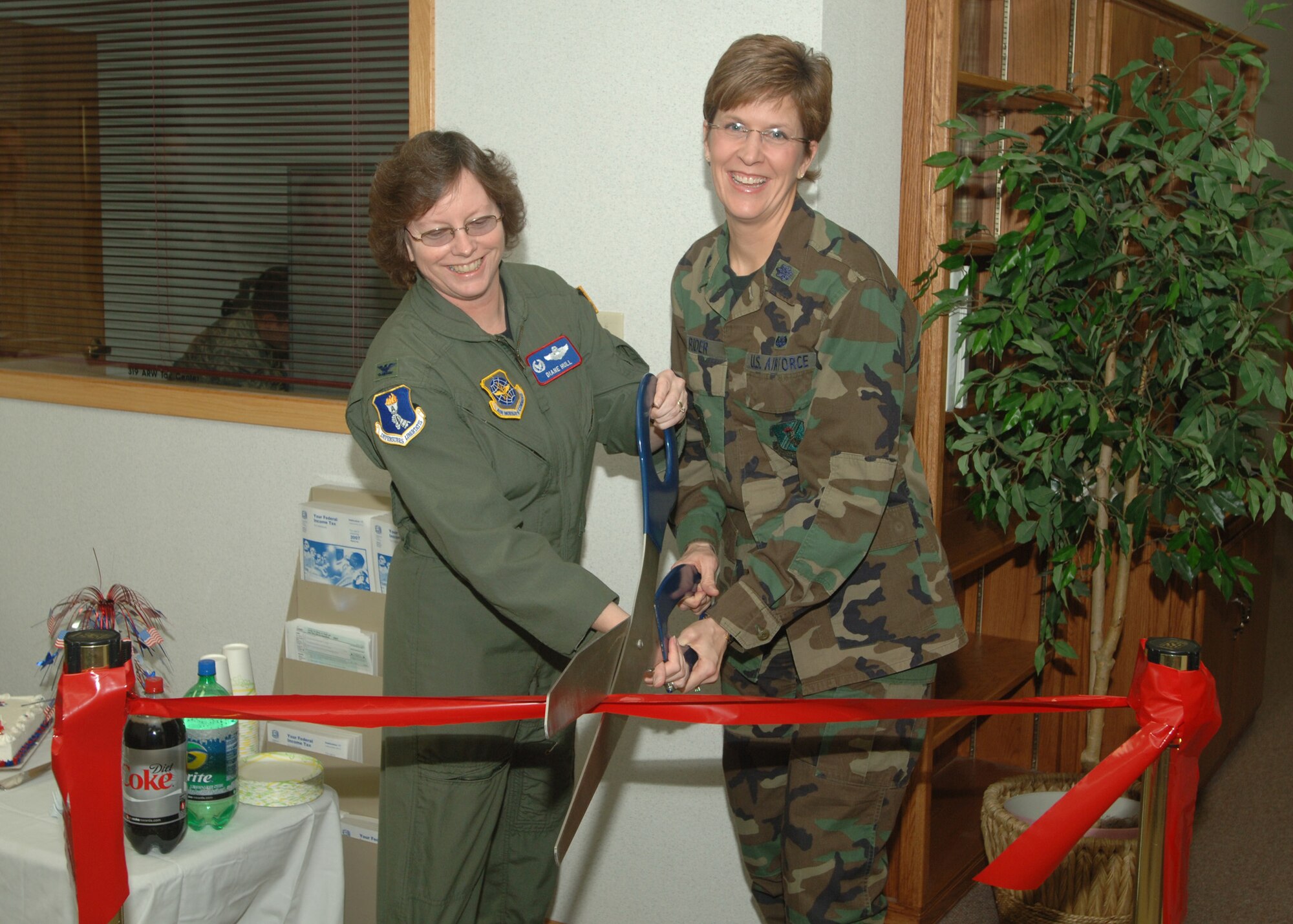 GRAND FORKS AIR FORCE BASE, N.D. - Col. Diane Hull and Lt. Col. Jennifer Rider cut the ribbon at the grand opening of the base's Tax Center here Feb. 5. The new facility offers more room and convenience for military members looking to file taxes during tax season. It is open from 8:30 a.m. to 4 p.m. Tuesday through Thursday with appointments available. (photo/SrA Chad Kellum)
