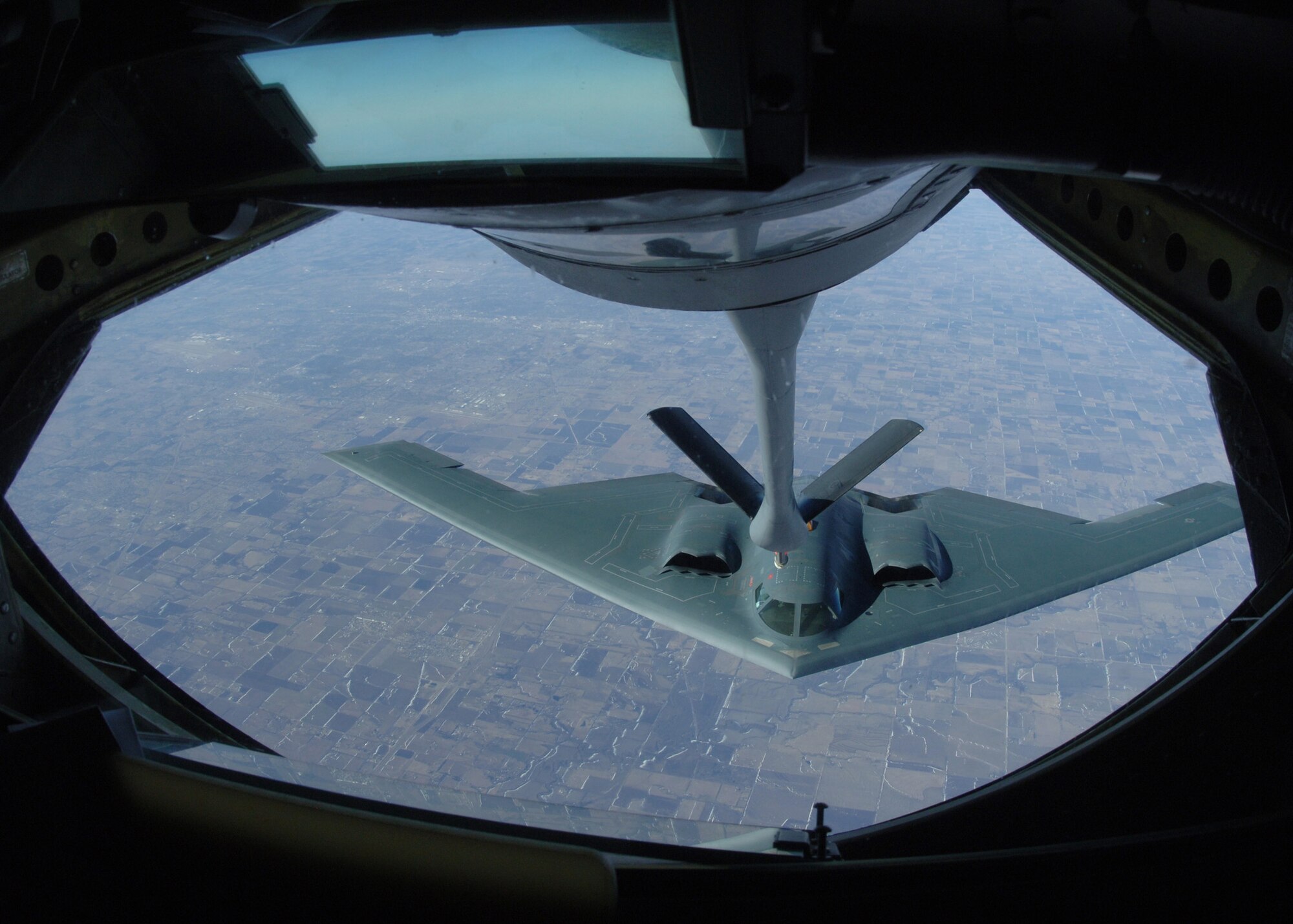 GRAND FORKS AIR FORCE BASE, N.D. - A B-2 Spirit approaches the boom of a 319th Air Refueling Wing KC-135 Stratotanker for aerial refueling over the skies of the Midwest. Able to fly more than 1,500 miles with 150,000 pound transferable of transferable fuel, the KC-135 enable global reach for U.S. and allied aircraft. (U.S. Air Force photo/Senior Airman Chad Kellum)