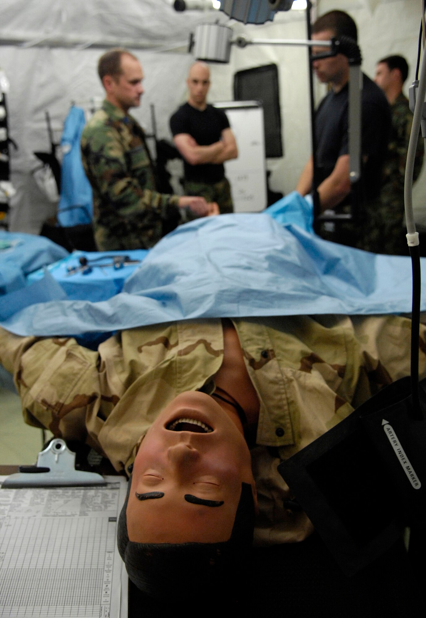 Lt. Col. Greg Schumacher explains concept fasciotomy to medics during Exercise Pacific Lifeline Feb. 5 at Kona International Airport, Hawaii. The Airmen are from the 3rd Medical Group from Elmendorf Air Force Base, Alaska. Pacific Lifeline is a total force exercise staging from three locations within the Hawaiian Islands. It provides approximately 900 Department of Defense members a test environment to rapidly deploy and provide time-critical services in the wake of a simulated natural disaster. (U.S. Air Force photo/Tech. Sgt. Shane A. Cuomo) 

