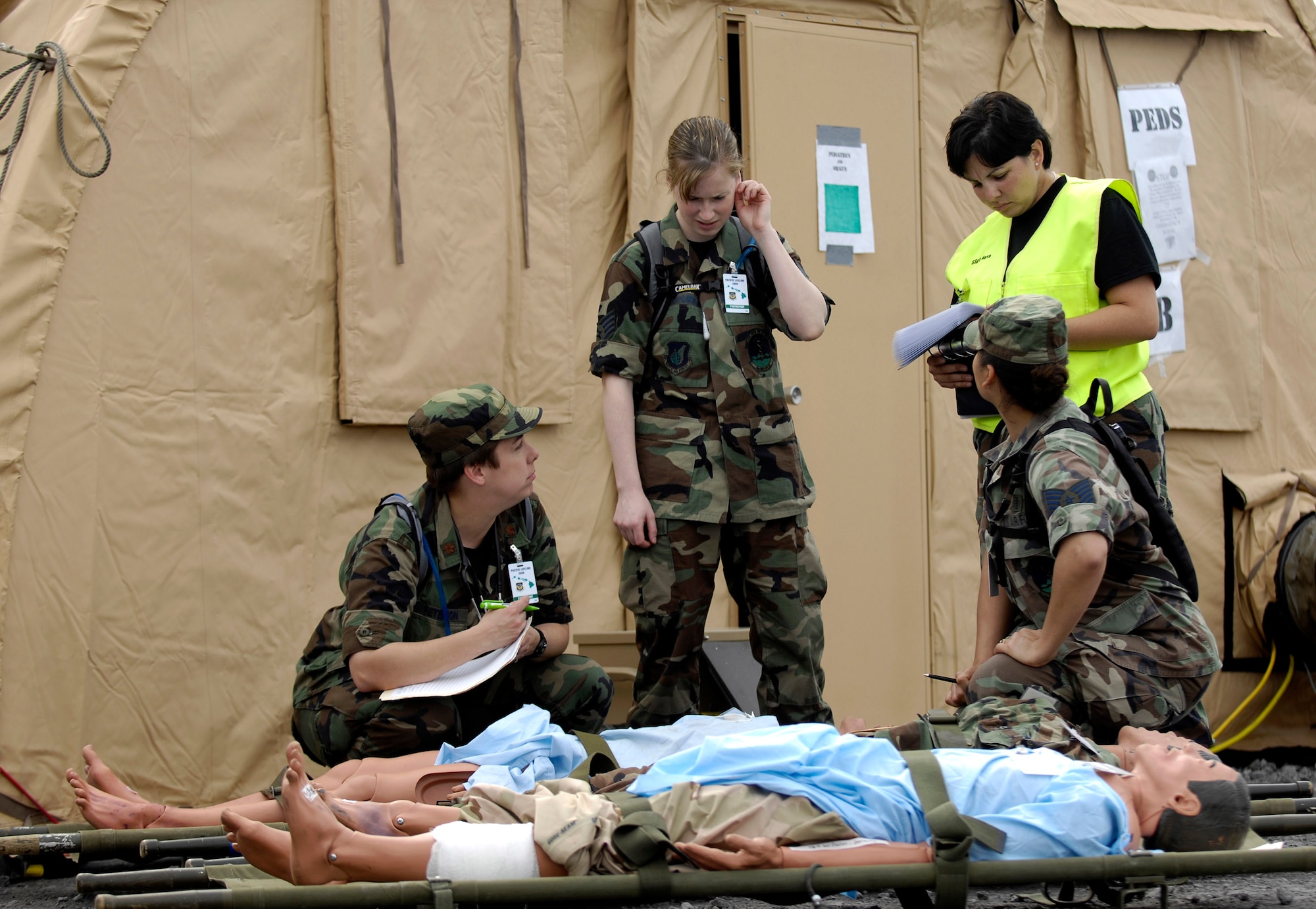 Medics run through a patient scenario during Exercise Pacific Lifeline Feb. 5 at Kona International Airport, Hawaii. Pacific Lifeline is a total force exercise staging from three locations within the Hawaiian Islands. It provides approximately 900 Department of Defense members a test environment to rapidly deploy and provide time-critical services in the wake of a simulated natural disaster. (U.S. Air Force photo/Tech. Sgt. Shane A. Cuomo) 
