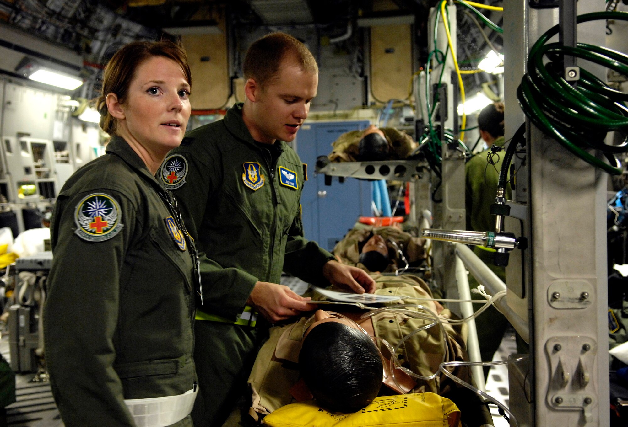 Senior Airman Suzanne Redd and Capt. Joe Foss tend to a "patient" on a C-17 Globemaster III during Exercise Pacific Lifeline Feb. 5 at Hickam Air Force Base, Hawaii. The Airmen are from the 446th Aeromedical Evacuation Squadron McChord Air Force Base, Wash. Pacific Lifeline is a total force exercise staging from three locations within the Hawaiian Islands. It provides approximately 900 Department of Defense members a test environment to rapidly deploy and provide time-critical services in the wake of a simulated natural disaster. (U.S. Air Force photo/Tech. Sgt. Shane A. Cuomo) 
