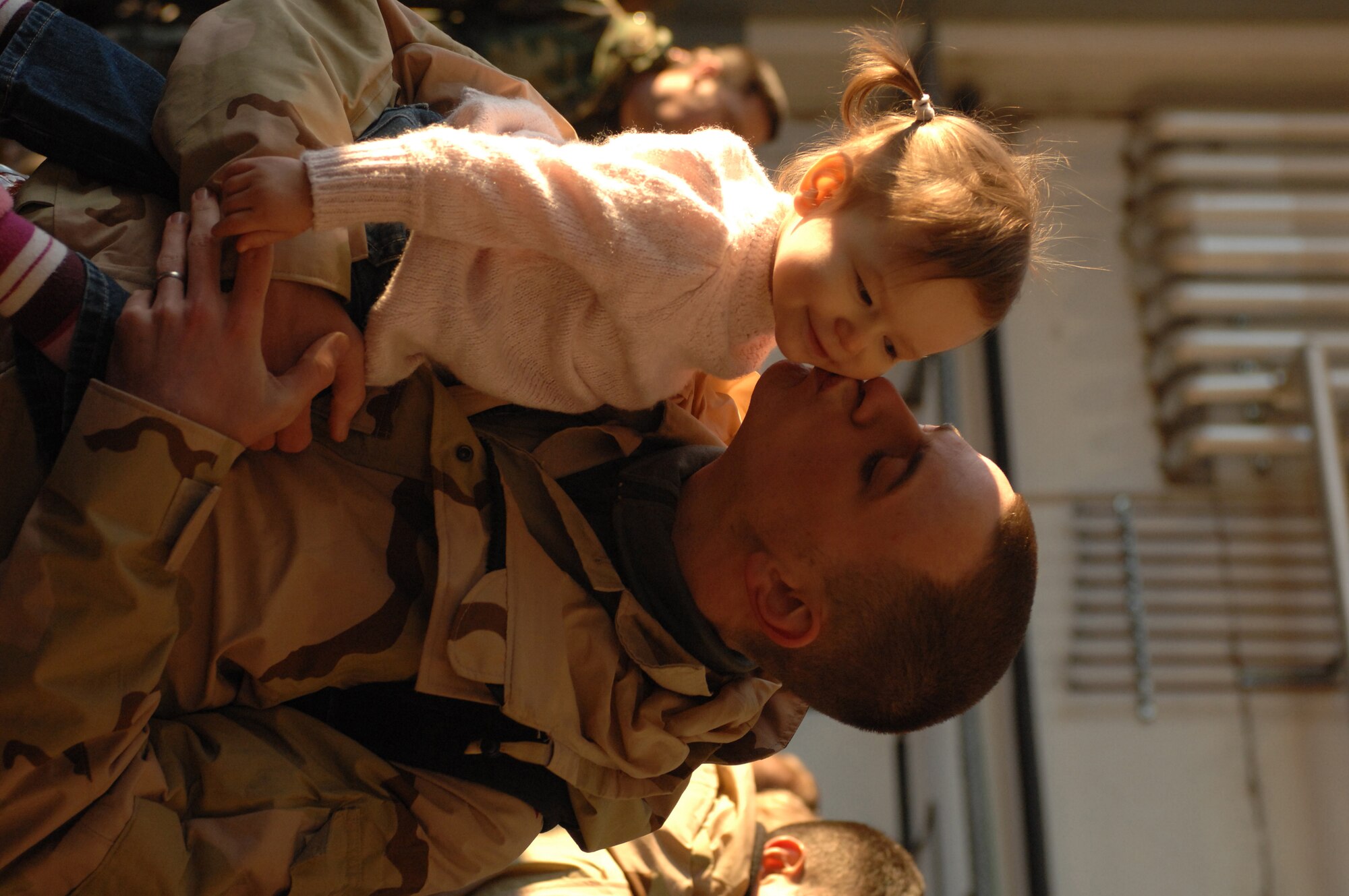 SPANGDAHLEM AIR BASE, Germany -- Senior Airman David Morgan, 52nd Aircraft Maintenance Squadron, kisses his daughter Chloe upon his return from a deployment in support of Operation Iraqi Freedom, Feb. 8, 2008. (U.S. Air Force photo/Senior Airman Kristin Ruleau) 