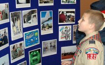 YOUNGSTOWN, Ohio - A young hockey fan studies a collection of photos at the Air Force Reserve's 910th Airlift Wing's Public Affairs Office display. The PA Office display was set up in the Chevrolet Centre's concourse downtown, Jan. 19, as part of the Youngstown SteelHounds professional hockey team's Military Night activities. U.S. Air Force photo by Tech. Sgt. Bob Barko Jr.