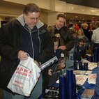 YOUNGSTOWN, Ohio - Hockey fans pick up some Air Force Reserve mementos and information at the 910th Recruiting Services Squadron table prior to the drop of the game's first puck. The recruiting display was set up in the main concourse of the Chevrolet Centre downtown, Jan. 19, as part of the Youngstown SteelHounds professional hockey team's annual Military Night activities. U.S. Air Force photo by Tech. Sgt. Bob Barko Jr.