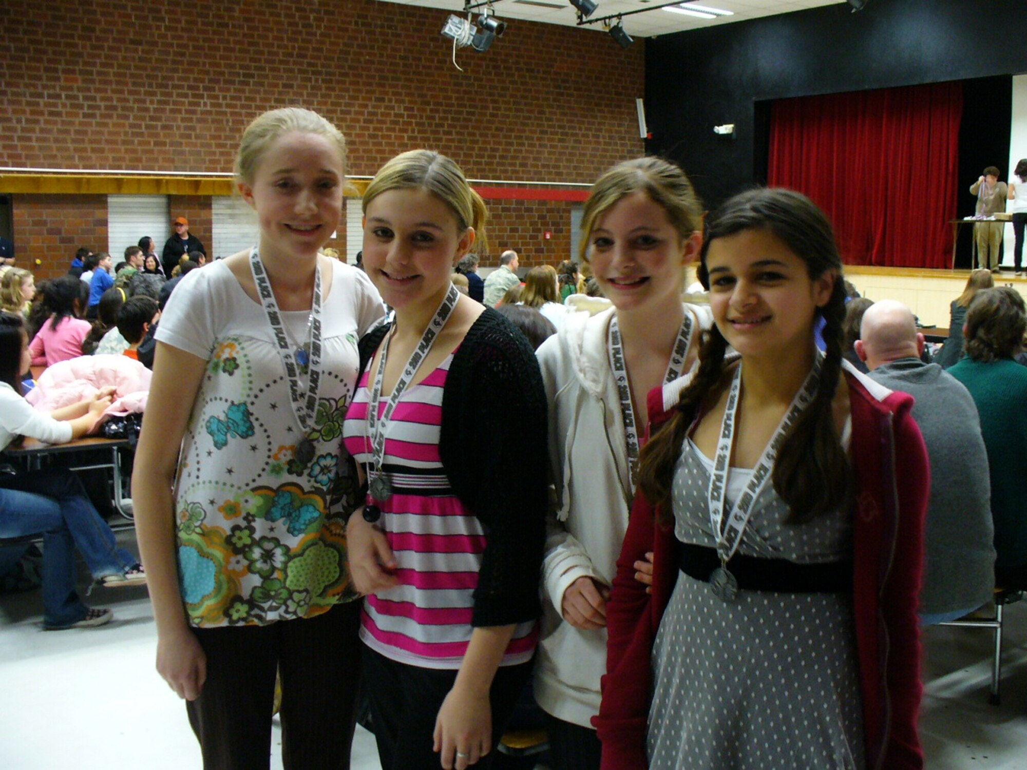 RAMSTEIN AIR BASE, Germany – (Left to right) Julie Hyatt, Megan Wray, Ashton Fair and Autumn Diaz enjoy their second place group performance victory at the Kaiserslautern National History Day competition themed "Conflict and Compromise" at Ramstein High School. The girls are all eighth grade students at Bitburg Middle School. Julie is the daughter of Master Sgt. Shannon Hyatt, 52nd Maintenance Group. Megan is the daughter of Master Sgt. Jody Wray, 52nd Mission Support Squadron. Ashton is the daughter of Master Sgt. Justin Fair, 52nd MXG. Autumn is the daughter of Staff Sgt. Mark Diaz, 52nd 726th Training Squadron. (Courtesy photo)