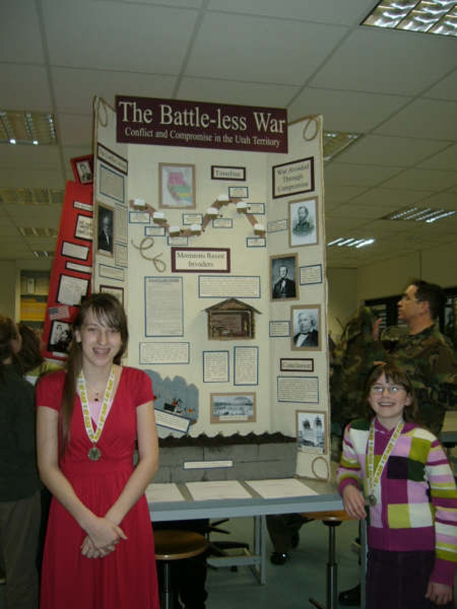 RAMSTEIN AIR BASE, Germany – (Left) Caitlin Roth and McKayla Boden stand by their first placing winning group exhibit entry in Kaiserslautern National History Day competition themed "Conflict and Compromise" at Ramstein High School. Both students are sixth graders at the Bitburg Middle School. Caitlin is the daughter of Lt. Col. Lawrence Roth, 52nd Dental Squadron and McKayla is the daughter of Maj. Stephen Boden, 52nd Medical Operations Squadron. (Courtesy photo)