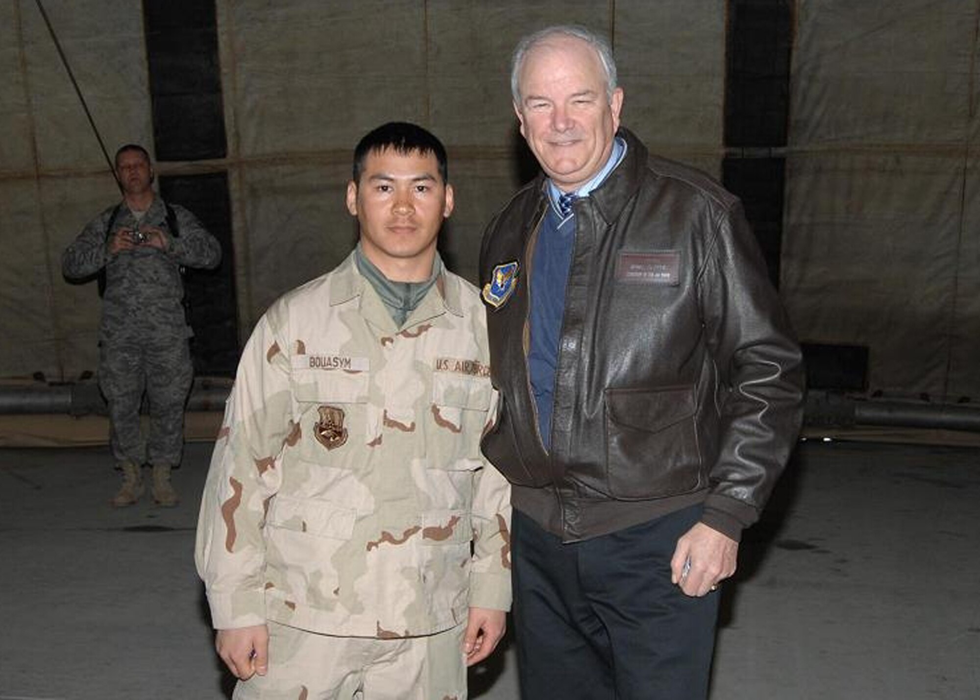 BAGRAM AIR BASE, Afghanistan – Secretary of the Air Force Michael W. Wynne recognizes Senior Airman Poutason Bouasym, 455th Expeditionary Aircraft Maintenance Unit, with his coin for his outstanding performance while deployed Feb. 4, 2008. Sergeant King is deployed from Spangdahlem Air Base, Germany. (U.S. Air Force photo/Master Sgt. Demetrius Lester)