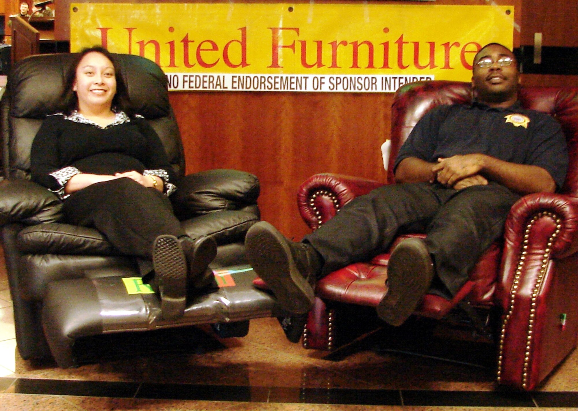 SPANGDAHLEM AIR BASE, Germany – Xenia Quicho, 52nd Equipment Maintenance Squadron, and Alfonso Whitaker, Customs Executive Agency, relax in their new recliners. The recliners were prizes in the 52nd Services Squadron UPICKEM Program. (Photo courtesy of 52nd Services Marketing Department)