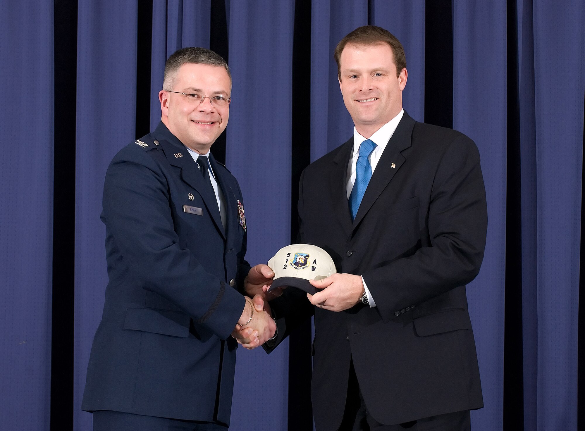 Col. Randal L. Bright, 512th Airlift Wing commander, presents a hat to Scott Lugar, ING DIRECT USA Head of Consumer Lending at 2008 Honorary Commander's induction ceremony at Dover Air Force Base Jan. 31. More than 50 community leaders were inducted as honorary commanders where they will interact with their Air Force active duty and Reserve counterparts. The program promotes understanding, appreciation and camaraderie between Dover Air Force Base members and the surrounding community. Throughout the year, honorary commanders will have the opportunity to tour the base and attend social function to interact with base Airmen and DoD employees. (U.S. Air Force photo/Jason Minto)