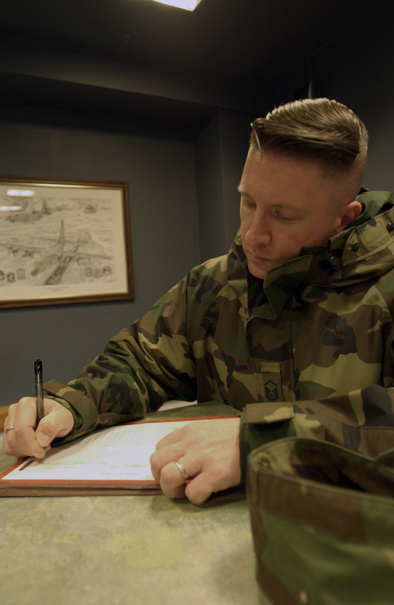 Master Sgt. Matthew Becker, 100th Mission Support Squadron, jots down notes while inspecting a dorm room for RAF Mildenhall's recent Dorm Excellence Competition. The 100th Maintenance Squadron was named as the winner, and was awarded $1,000 for quality-of-life upgrades. (U.S. Air Force photo by Senior Airman Clark Staehle)