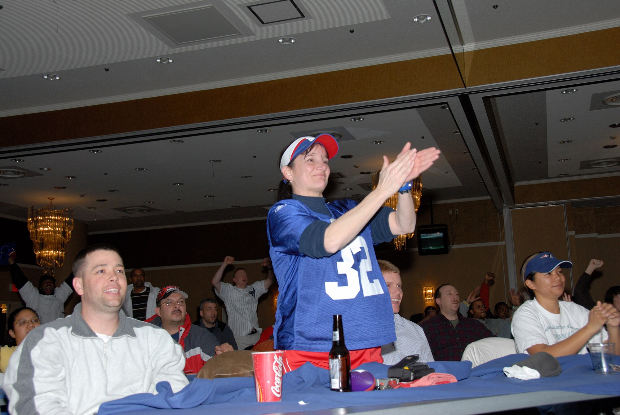 MISAWA AIR BASE, Japan -- Master Sgt. Renee Newpher, 35th Maintenance Group, claps loudly as the New York Giants stop a pass by the New England Patriots during Superbowl XLII, Feb. 4, 2008.  Sergeant Newpher joined more than 400 base members at the Tohoku Enlisted club to watch the game on a 10' x 14' screen.  (U.S. Air Force photo by Senior Airman Laura R. McFarlane)