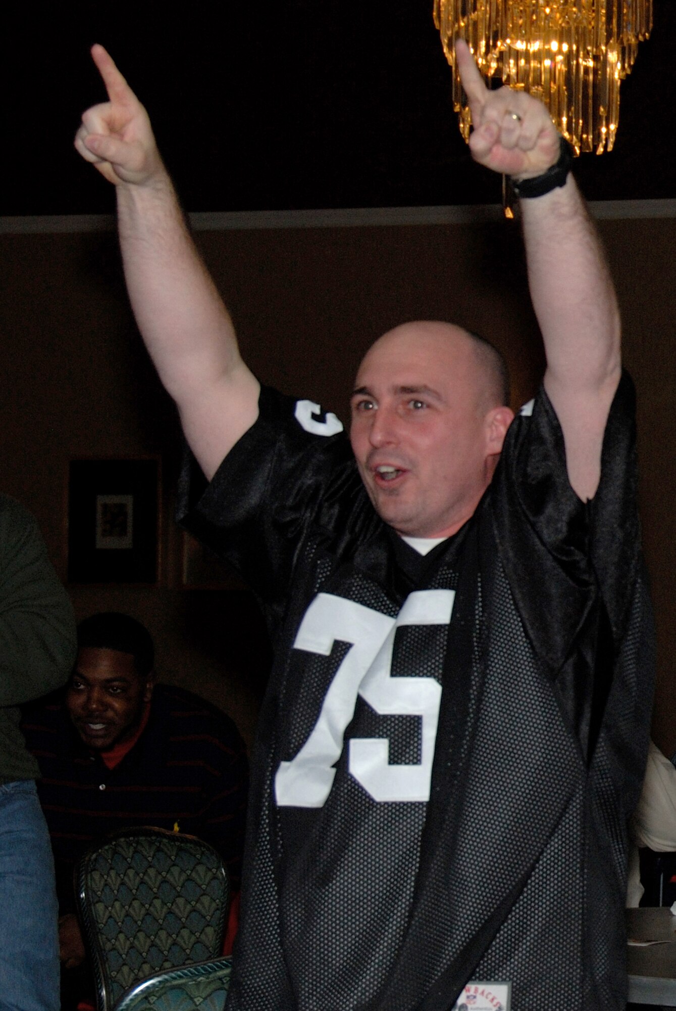 MISAWA AIR BASE, Japan -- Tech. Sgt. Michael Daniel, 35th Medical Support Squadron, cheers during Superbowl XLII, Feb. 4, 2008.  The club sponsors an annual Superbowl party.  (U.S. Air Force photo by Senior Airman Laura R. McFarlane)