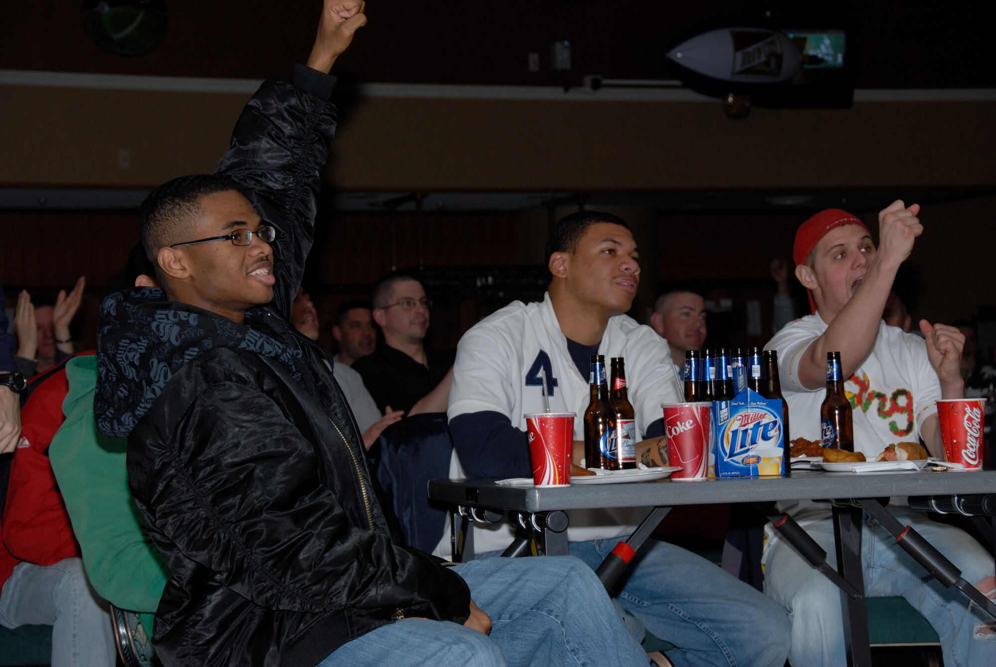 MISAWA AIR BASE, Japan -- (Left to right) Airman 1st Class Torres Walker, Airman 1st Class Ricky Parham, both 35th Communications Squadron members, and Airman 1st Class Jeremiah Hollandsworth, 14th Fighter Squadron, cheer as the New York Giants score a first down during Superbowl XLII, Feb. 4, 2008.  Airman Walker was cheering -- on his team, the Giants, and Airman Hollandsworth was cheering for the Giants because he didn't want the New England Patriots to win.  (U.S. Air Force photo by Senior Airman Laura R. McFarlane)