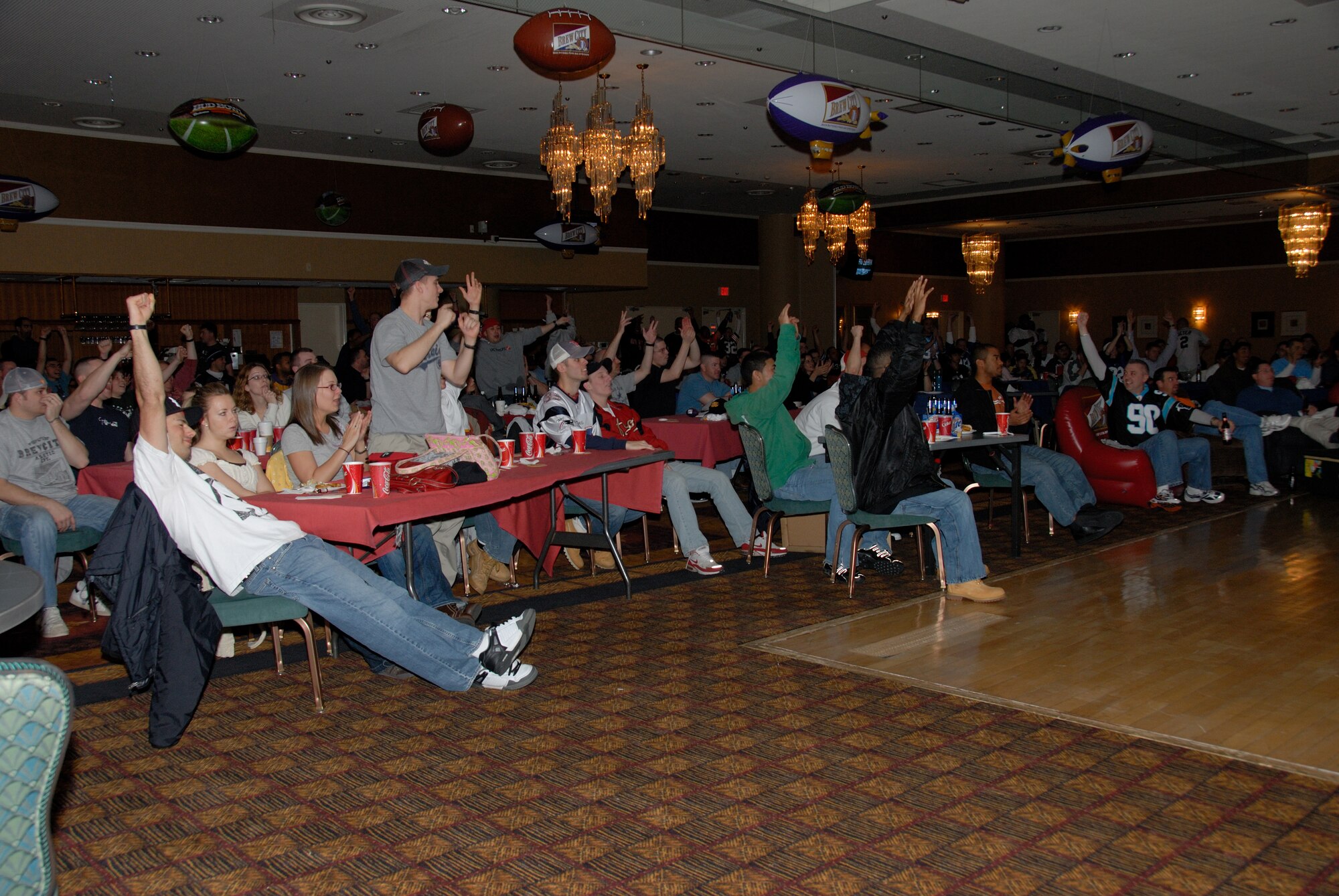 MISAWA AIR BASE, Japan -- Base members gathered at the Tohoku Enlisted club cheer as the New York Giants score a touchdown putting the Superbowl XLII score 9-7 in their favor, Feb. 4, 2008.  That Monday was dedicated as wing down day so that people could watch the Superbowl.  (U.S. Air Force photo by Senior Airman Laura R. McFarlane)