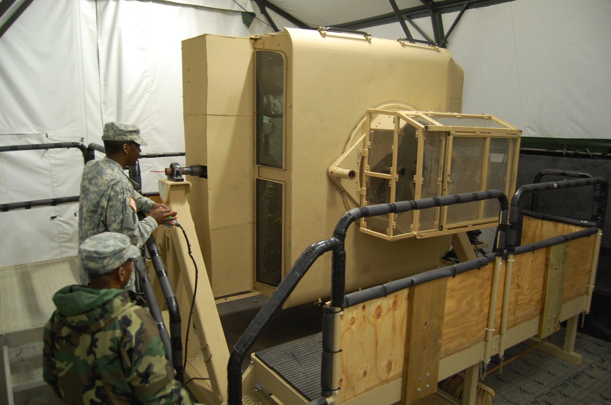 Army Staff Sgt. Carl Burrow (foreground) and Sgt. Cassius Harris (background) manipulate the H.E.A.T. trainer humvee for the crew inside. A Scripps-Howard News Service analysis from 2005 stated 1 in 4 casualties in the theater of operations were related to humvee accidents and rollovers during IEDs and other attacks and incidents. The H.E.A.T., or “HMMWV Egress Assistance Training,” prepares service members on how to react in the event their humvee rolls over.   (U.S. Air Force photo/Capt. Ken Hall)