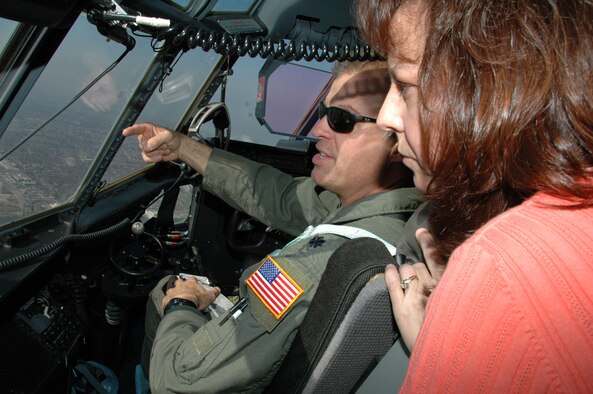 Soaring over the Gulf Coast, Lt. Col. Keith Gibson, a pilot for the 815th Airlift Squadron,  points out several New Orleans landmarks to Valerie Martin during a 403rd Wing spouse orientation flight. Eight wives of 403rd Wing members rode along on the flight during the February Unit Training Assembly. Families are the most important part of the support system for Reservists making it possible for them to serve their country.