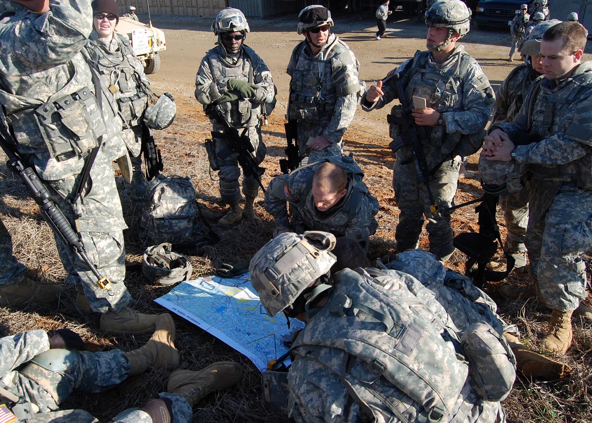 Staff Sgts. Kacy Harvey (standing, wearing black watchcap) and Xerona Moore (standing, hands crossed) receive a mounted combat patrol briefing from Pennsylvania National Guardsman Sgt. Jamey Yurkonis at Forward Operating Base Patriot located on Fort Bragg, N.C. These members of Provincial Reconstruction Team Gardez complete their combat skills training this month before forward deploying to Paktya Province near the Pakistan border in Afghanistan. The Airmen and Soldiers who formed the core of the PRT joined with Pennsylvania National Guardsmen assigned to the 3-103d Armor who will perform security forces functions for the PRT in country. Sergeant Yurkonis is a former Marine Corps Gunnery Sergeant who came back into the military. (U.S. Air Force photo/Capt. Ken Hall)