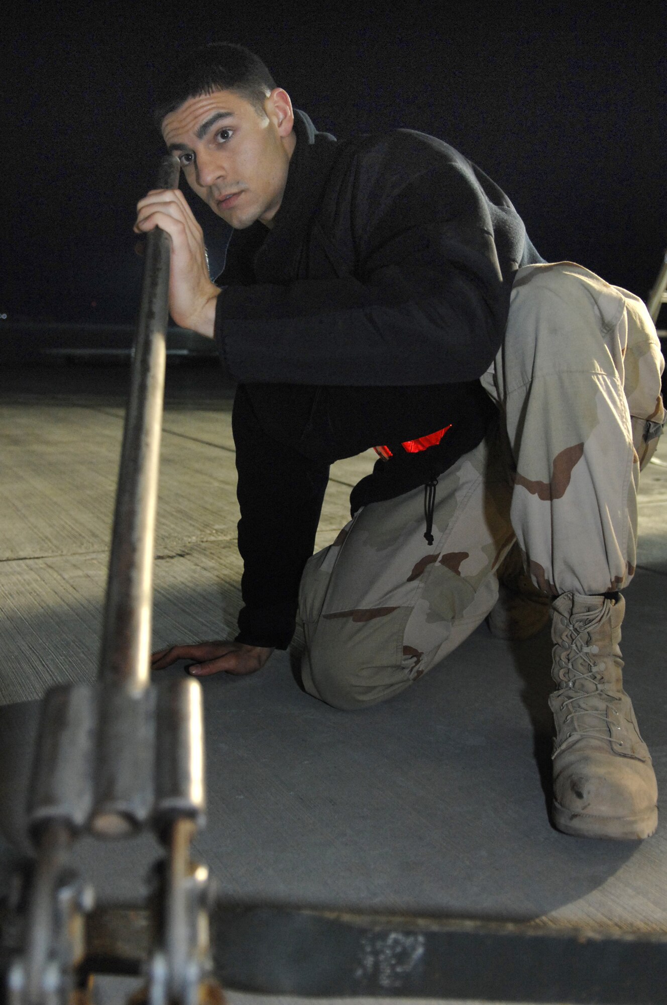 BALAD AIR BASE, Iraq -- Airman 1st Class Richard Garner, 721st Air Mobility Maintenance Group Detachment 5 crew chief, pumps up a jack for a C-17 before performing maintenance here, Feb. 8. The C-17, from Travis Air Force Base, Calif., had a rolled and exposed seal in the nose landing gear strut assembly, which could have caused decompression of the hydraulic fluid stored inside to cushion landing. Ensuring aircraft are returned to operational status in a timely manner is imperative to mission success. Airman Garner is deployed from Travis Air Force Base, Calif. (U.S. Air Force photo/ Senior Airman Julianne Showalter)