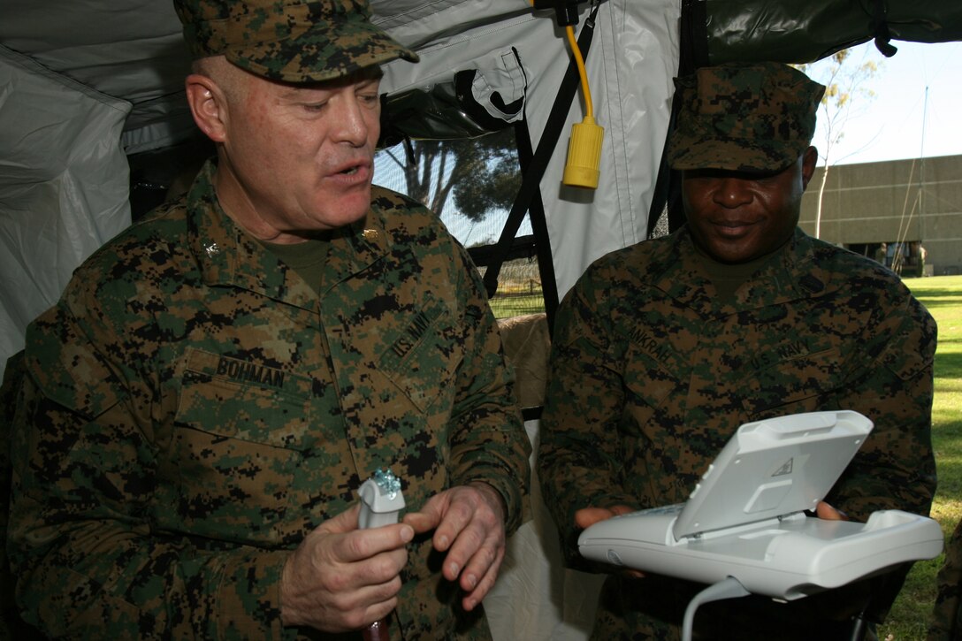 080209-M-2708O-0124.jpg ER.007 NAVY MARINE CORPS RESERVE CENTER SAN DIEGO - Navy Capt. Navy Capt. Harold R. Bohman, Chief of Professional Services with 1st Medical Battalion, Combat Logistics Regiment 15, 1st Marine Logistics Group, demonstrates how to use a portable sonogram to corpsmen, with the help of Petty Officer 3rd Class Robert K. Ankrah, a corpsman with Co. B., 4th Medical Battalion, 4th Marine Logistics Group, during annual training at the Navy Marine Corps Reserve Center San Diego, Feb. 9. The sonogram, while traditionally used to examine unborn children; helps corpsmen see any broken bones or debris trapped inside a body. Bohman is a native of Oceanside Calif.  (U.S. Marine Corps photo by Lance Cpl. Christopher A. O'Quin) (Released)
