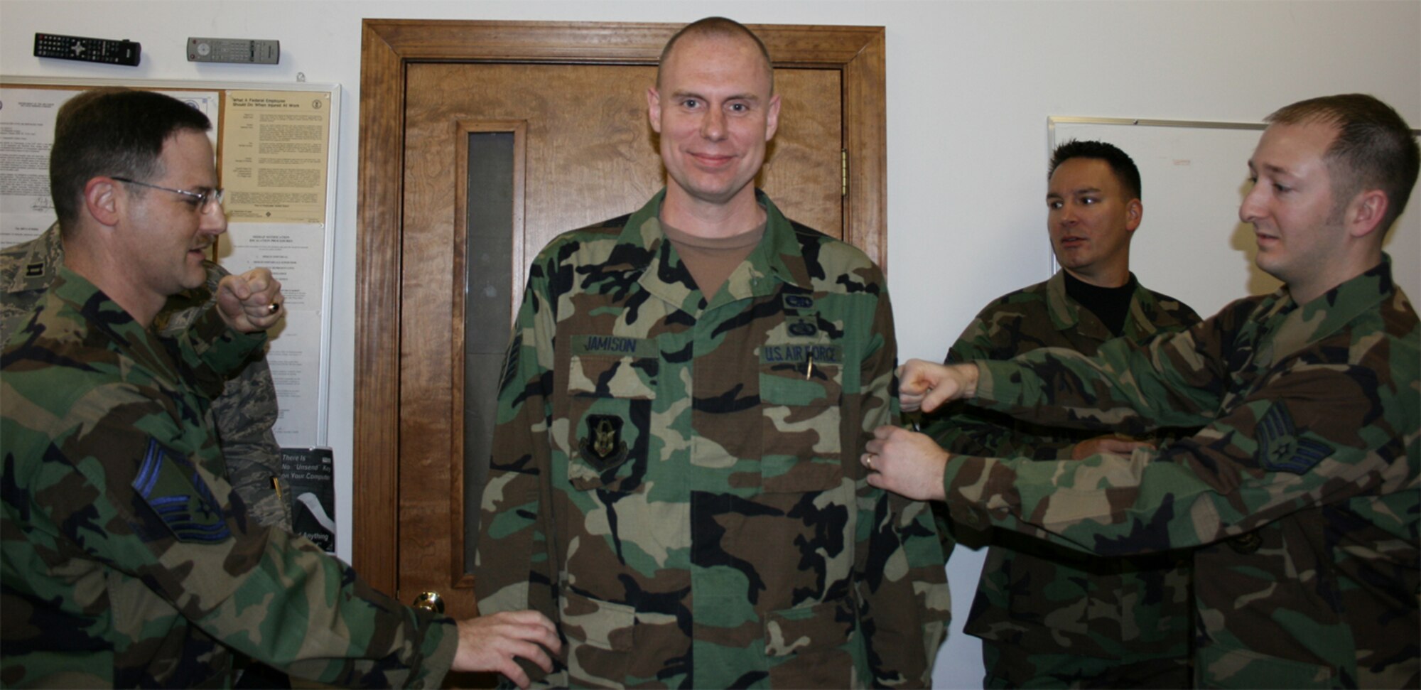 SEYMOUR JOHNSON AIR FORCE BASE, N.C.-- Master Sgt. Matt Jamison (middle) is promoted to his new rank during the 916th Air Refueling Wing's February unit training assembly. Sgt. Jamison is the non-commissioned officer in charge of special projects for the 916th Communication Squadron and has been with the Air Force Reserve wing for six years. U.S. Air Force photo/MSgt. Shane Lynch
