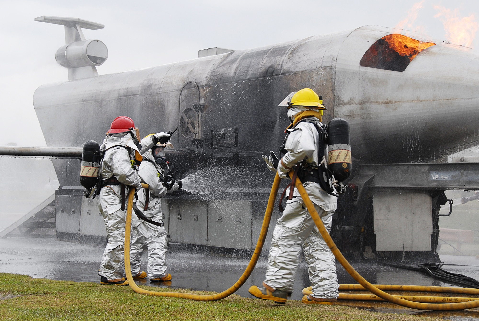 Firefighters from the 18th Civil Engineer Squadron, attempt to put out a simulated Kadena-based U.S. Navy P-3 Orion aircraft fire during Local Operational Readiness Exercise Beverly High 08-4 here, Feb. 10, 2008. The 18th Wing conducted Beverly High 08-4 from Feb. 10 to 15 to test Airmen's ability to respond in contingency situations. (U.S. Air Force photo/Tech. Sgt. Anthony Iusi)