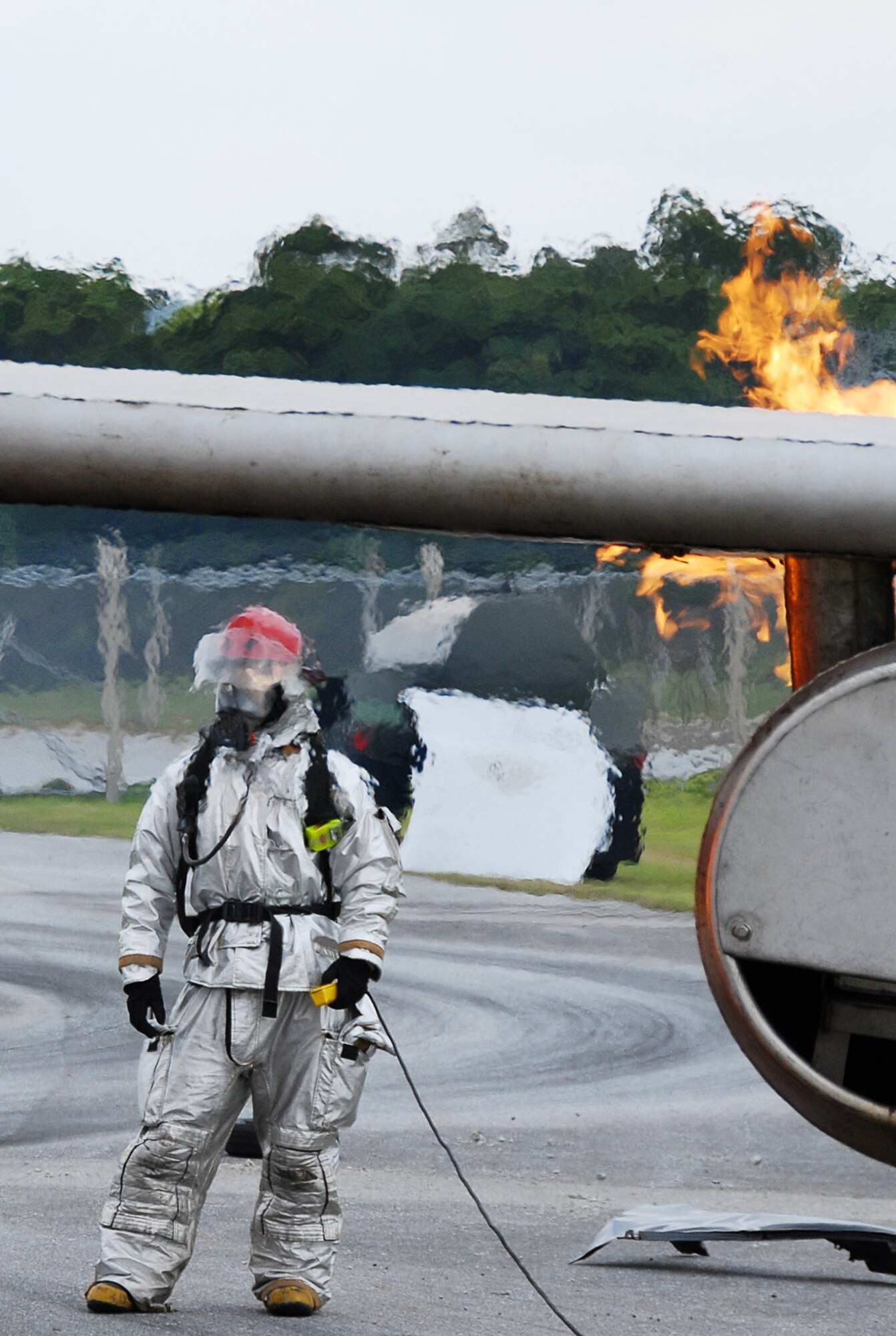 A firefighter from the 18th Civil Engineer Squadron, responds to a simulated Kadena-based U.S. Navy P-3 Orion aircraft fire during Local Operational Readiness Exercise Beverly High 08-4 here, Feb. 10, 2008. The 18th Wing conducted Beverly High 08-4 from Feb. 10 to 15 to test Airmen's ability to respond in contingency situations. (U.S. Air Force photo/Tech. Sgt. Anthony Iusi)