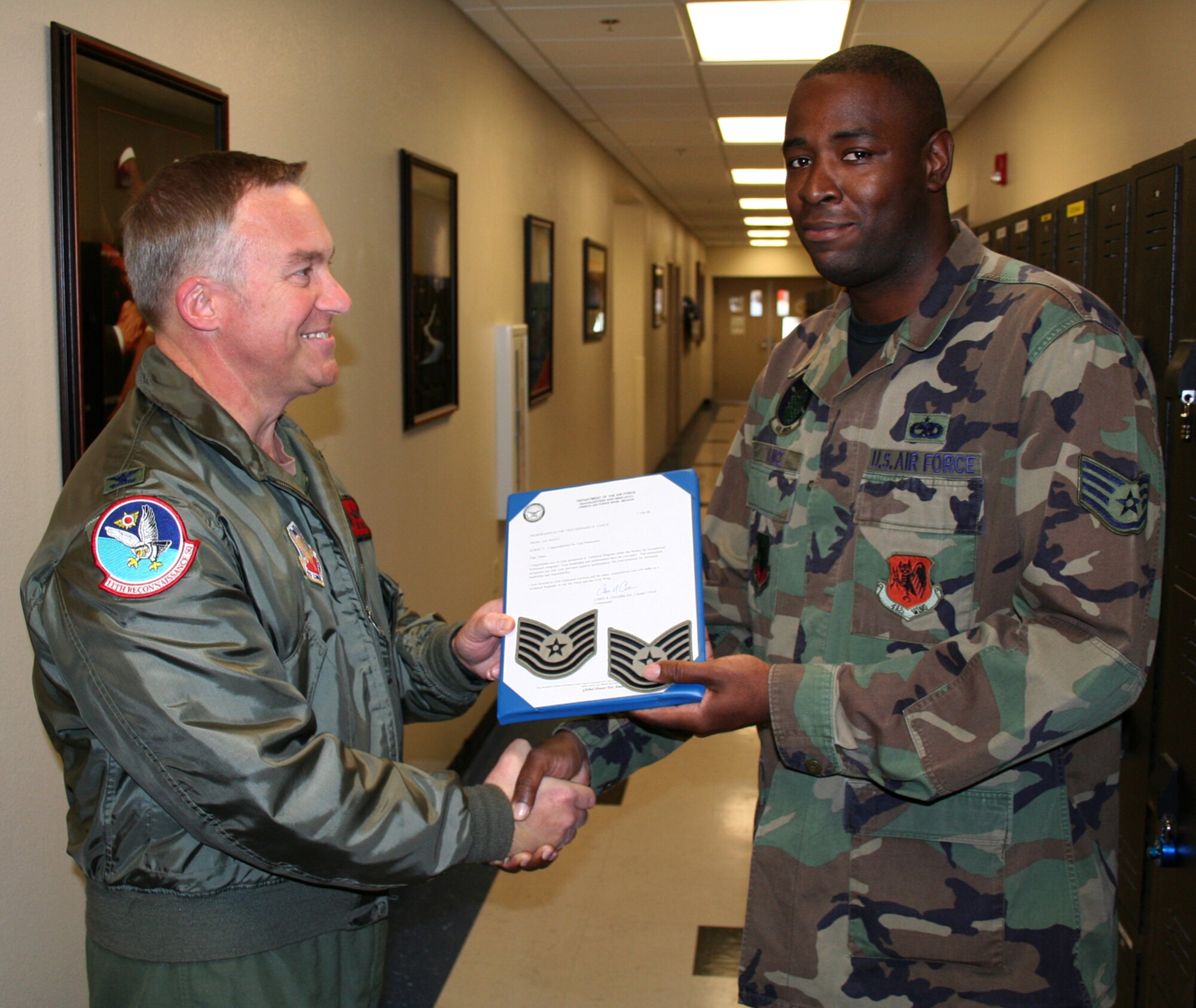 CREECH AIR FORCE BASE, Nev.—Col. Chris R. Chambliss, 423nd Wing commander, promotes Staff Sgt. Demario Vance, 432nd Aircraft Maintenance Squadron communications maintenance specialist, to the rank of technical sergeant as part of the Air Force’s Stripes for Exceptional Performers program here Feb. 7. (U.S. Air Force photo by Airman 1st Class Desmond L. Abrams)