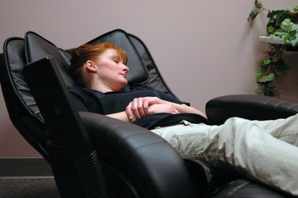 Staff Sgt. Misty Horton, dietary therapist, from the 21st Aerospace Medicine Dental Squadron, demonstrates the massage chair in the Relaxation Room at Peterson Air Force Base Health and Wellness Center. Relaxation is the mission on Feb.23, 2008 when the Family HEARTS/Key Family Member Program hosts a “Free Spa Event." (U.S. Air Force photo/Staff Sgt. Derrick M. Gildner)