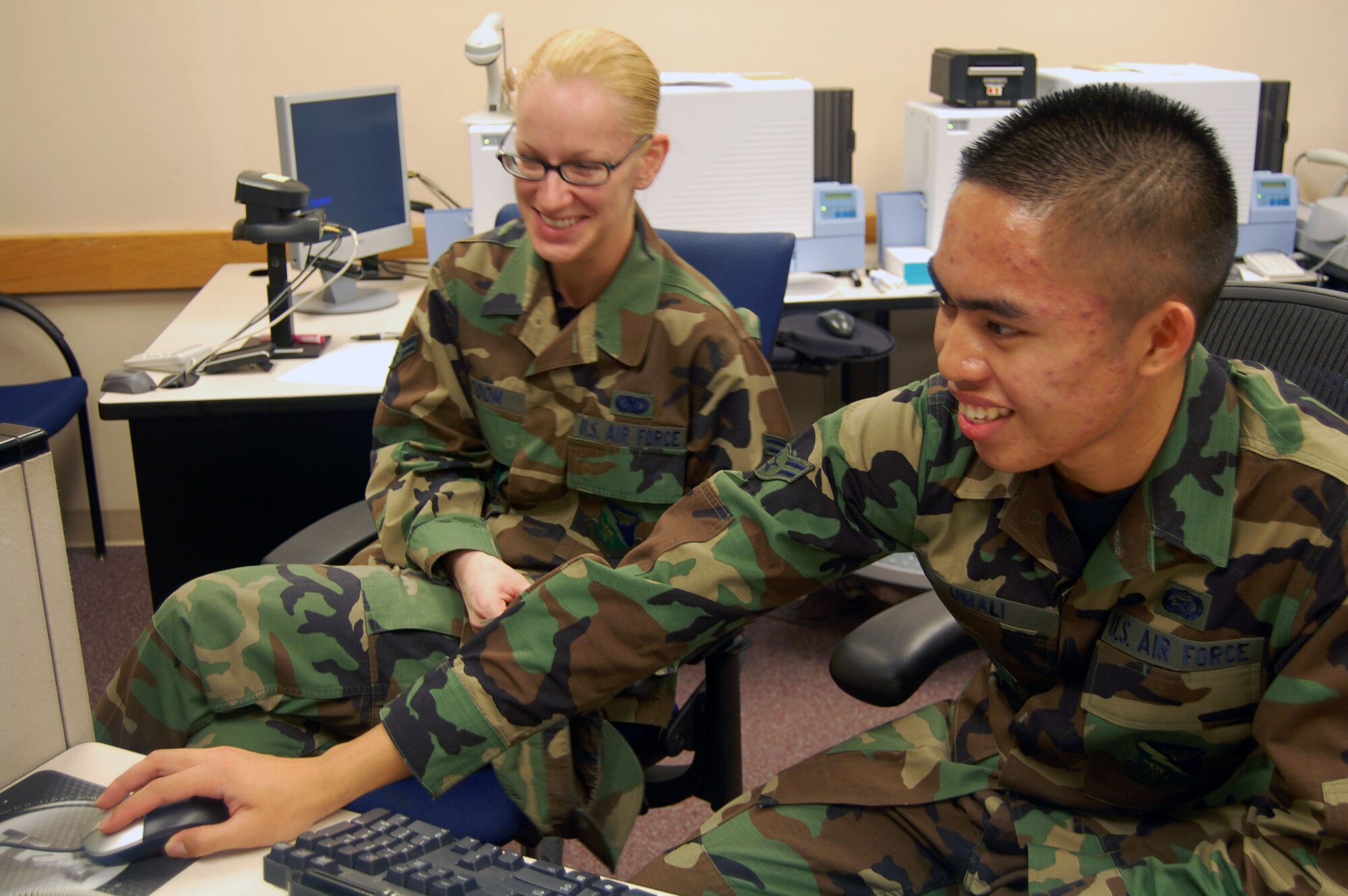 LAUGHLIN AIR FORCE BASE, Texas -- Airman 1st Class Jim Umali, 47th Force Support Squadron, shows Airman 1st Class Kristen Odom, 47th Mission Support Group, how to update her assignment dream sheet and Servicemember’s Group Life Insurance paperwork at the Laughlin’s Military Personnel Flight help desk Feb. 11, 2008.  MPF Airmen are responsible for updating and processing members’ data and personnel records, ranging from assignment notifications, evaluations and promotions to awards and decorations. They also assist applicants with accessing the virtual MPF and answering general questions about their personnel issues. “I like my job because it gives me the opportunity to meet people,” said Airman Umali. “Every time someone new comes to Laughlin, I get to meet them. I really enjoy doing this job”(U.S. Air Force photo by Airman 1st Class Sara Csurilla)