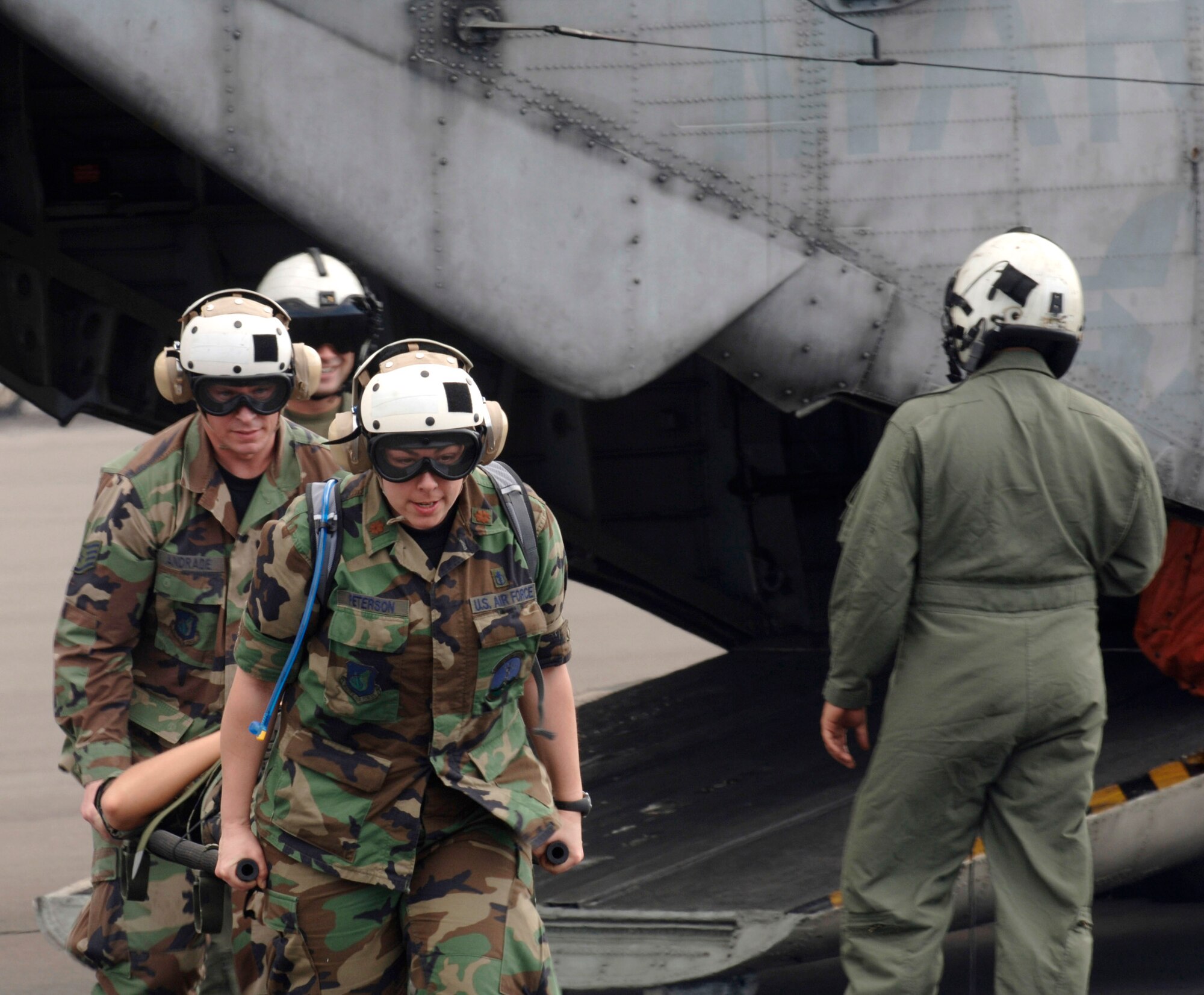 Maj. Laura Peterson and Tech. Sgt. Marcus Andrade hone their helicopter evacuation skills during a Pacific Lifeline training exercise Jan. 30 at the Kona International Airport at Kona, Hawaii. The 363rd Heavy Mobile Helicopter Squadron, Kaneohe Marine Corps Base, Hawaii, provided a CH-53D Sea Stallion and aircrew members to provide realistic hands-on training. Major Peterson and Sergeant Andrade are from the 3rd Expeditionary Medical Squadron from Elmendorf Air Force Base, Alaska. More than 80 members of the 3rd EMEDS participated in the humanitarian assistance and disaster relief exercise that took place from three locations within the Hawaiian Islands Jan. 20 to Feb. 9. (U.S. Air Force photo/Staff Sgt. Patrick Mitchell) 

