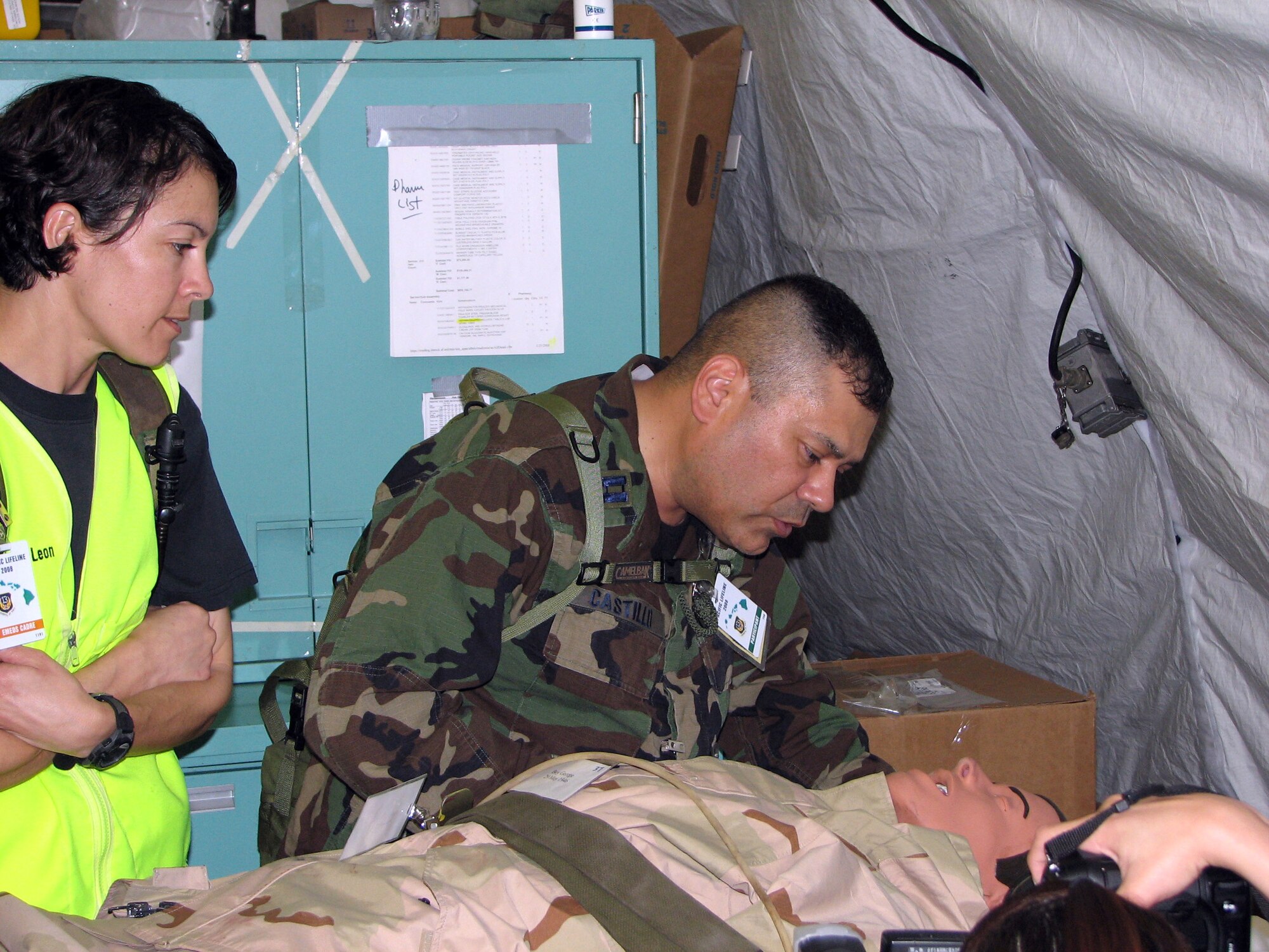 Chaplain (Capt.) Paul Castillo consoles a simulated patient while receiving injects from Tech. Sgt. Belen DeLeon during a mass casualty exercise Feb. 4 the Kona International Airport in Kona, Hawaii. Chaplain Castillo deployed to the Kona International Airport to participate in exercise Pacific Lifeline from Andersen Air Force Base, Guam. Chaplain Castillo is a protestant chaplain assigned to the 36th Wing from Andersen AFB, and Sergeant DeLeon is an Air Force School of Aerospace Medicine instructor from Brooks City-Base, Texas. (U.S. Air Force photo/Senior Master Sgt. Charles Ramey) 

