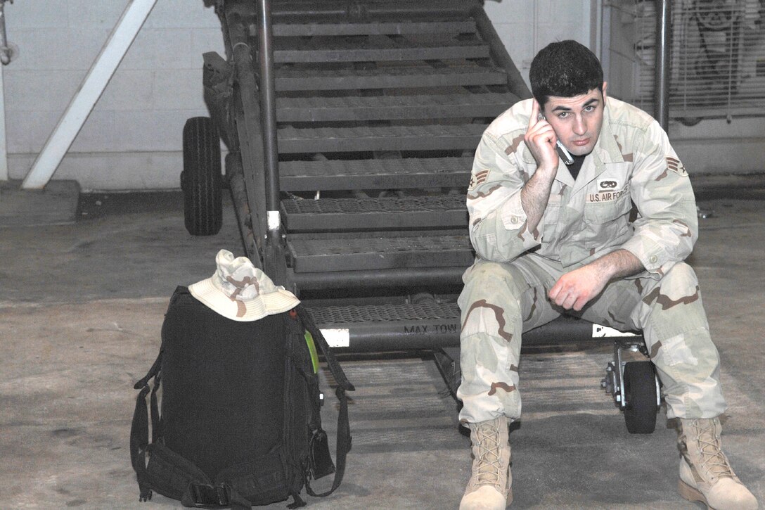 DYESS AIR FORCE BASE, Texas -- Senior Airman Matthew Orr, 317th Aircraft Maintenance Squadron, talks on the phone before leaving on a deployment to Southwest Asisa Feb. 10. (U.S. Air Force photo by Airman 1st Class Jennifer Romig)