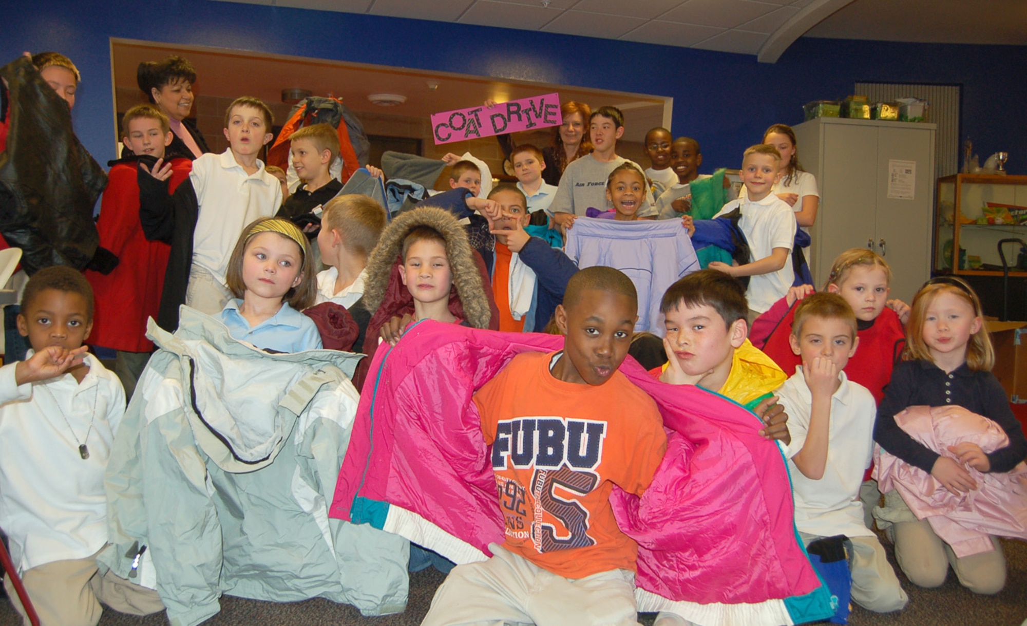 Children at the R. P. Lee Youth Center show off the coats they collected through the center’s month-long coat drive at Peterson Air Force Base, Colo., Feb. 5. The center’s families and staff collected five boxes of coats and other cold weather gear for the Marian House, a local charity. (U.S. Air Force photo/Corey Dahl)