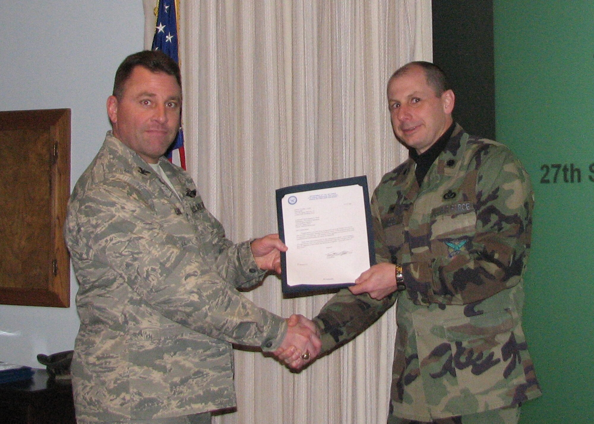 CANNON AIR FORCE BASE,  N.M. -- Colonel Timothy Leahy, 27th Special Operations Wing Commander, presents the 2008 Air Force Association's "Theodere Von Karman Award" to Lt. Col. Stephen Wood, 27th Special Operations Civil Engineering Squadron on Feb. 5. The Award is presented for distinguished achievement in engineering mechanics, applicable to any branch of civil engineering. (US Air Force photo by Master Sgt. Cynthia Crouch) 