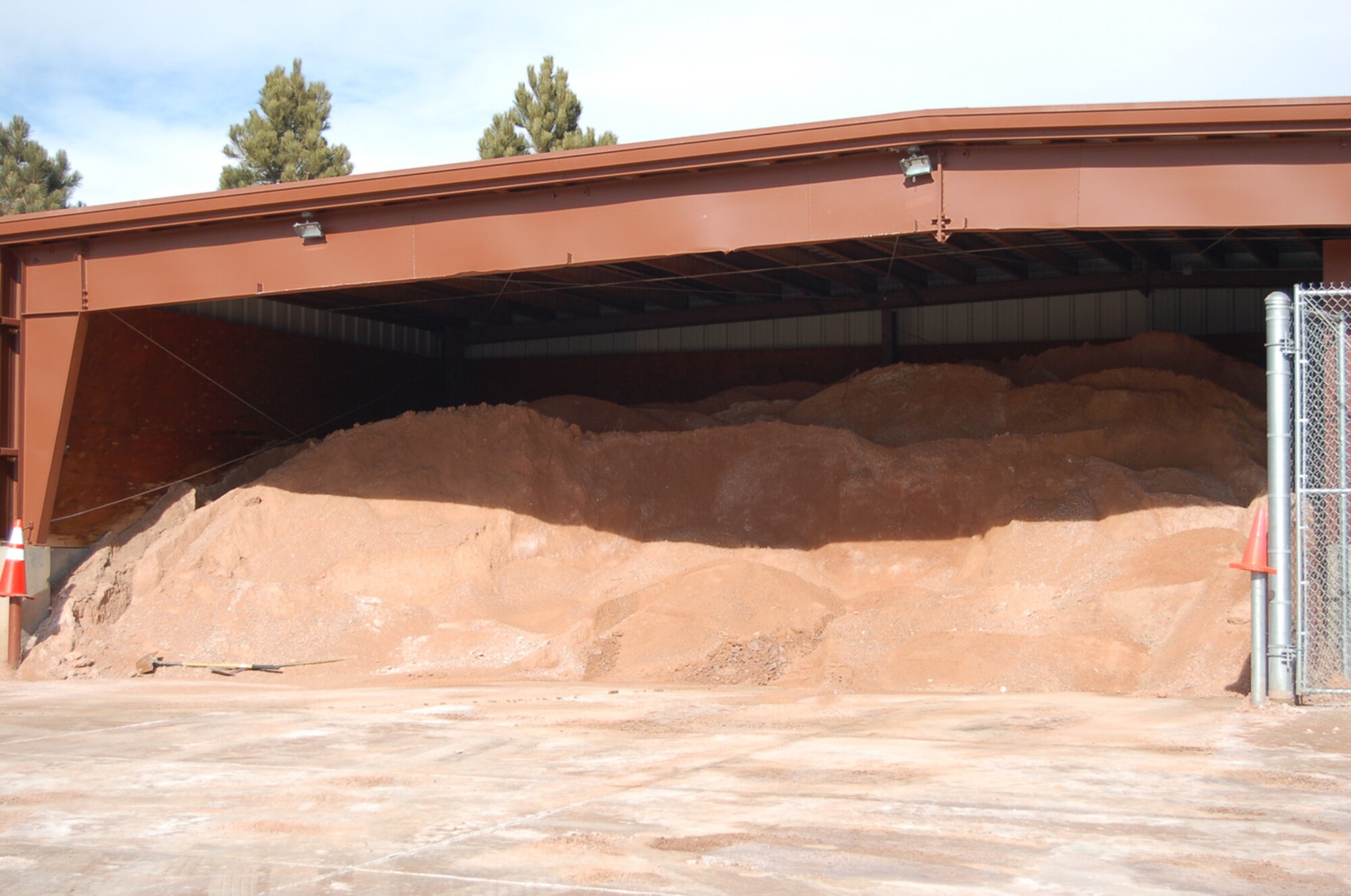 A large shed houses several tons of solid chemical de-icer near the 21st Civil Engineer Squadron building. Road crews use roughly 20 tons of the solid de-icer during an average storm and also spray about 1,300 gallons of liquid de-icer prior to most storms. (U.S. Air Force photo/Corey Dahl)