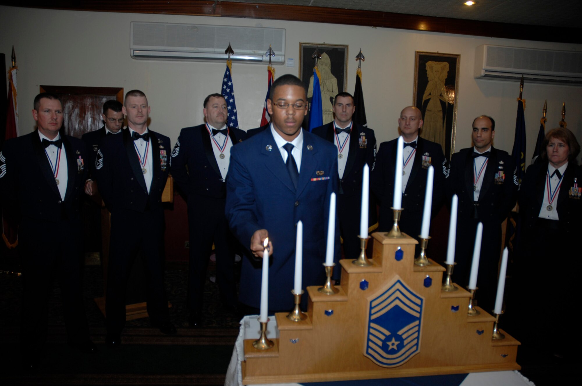 Airman Basic Lenier Petite, 100th Aircraft Maintenance Squadron, lights the first candle during the United Kingdom Chief’s Recognition Ceremony at RAF Lakenheath Feb. 9. Tradition states a member of each rank lights a candle signifying the transition through the ranks from Airman Basic to Chief Master Sergeant. (U.S. Air Force photo by Senior Airman Brian Ellis)
