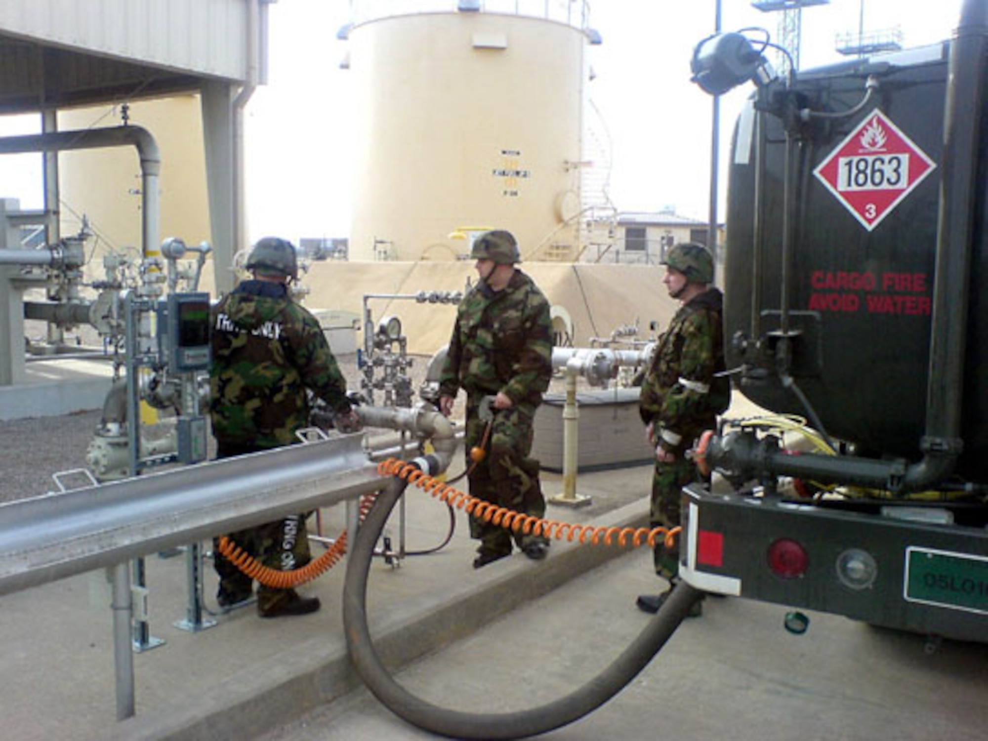 It takes 6,000 gallons of JP-8 fuel to fill an R-11 fuel truck. Senior Airmen Shaun Colvard, Brandon Bensch, and Roger Kubilis keep a watchful eye over the pumping operation.
