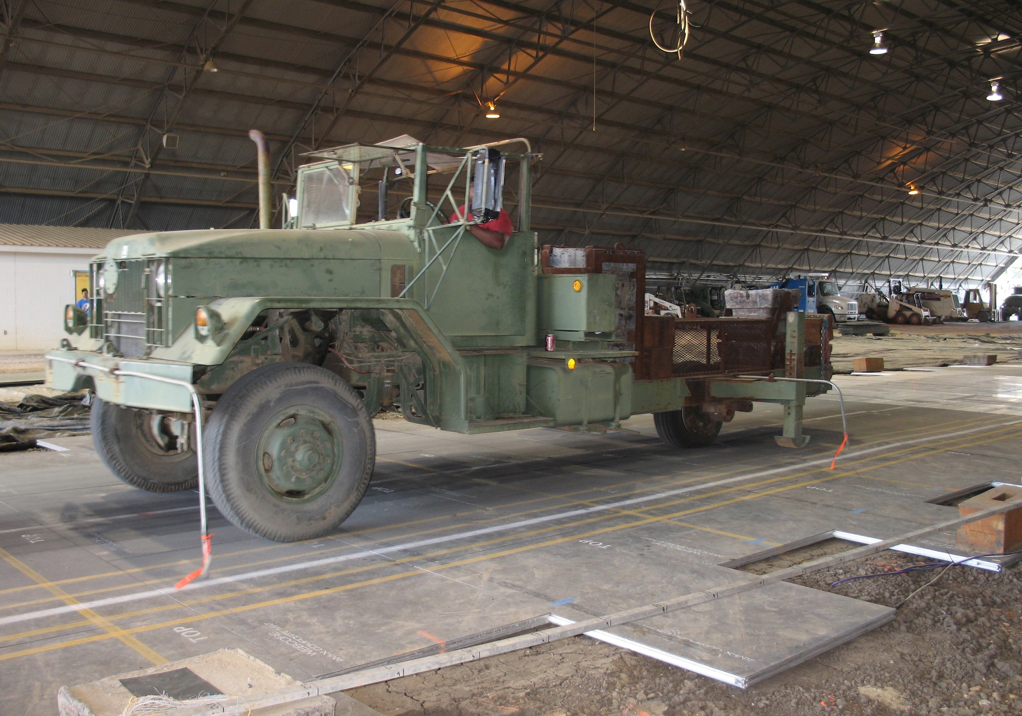 Working in partnership with industry, Air Force Research Laboratory has developed lightweight composite next generation panels to support aircraft as airfield matting at austere airfields.  Here, a vechicle is used to test the new panel’s weight-bearing ability. (U.S. Air Force photo) 