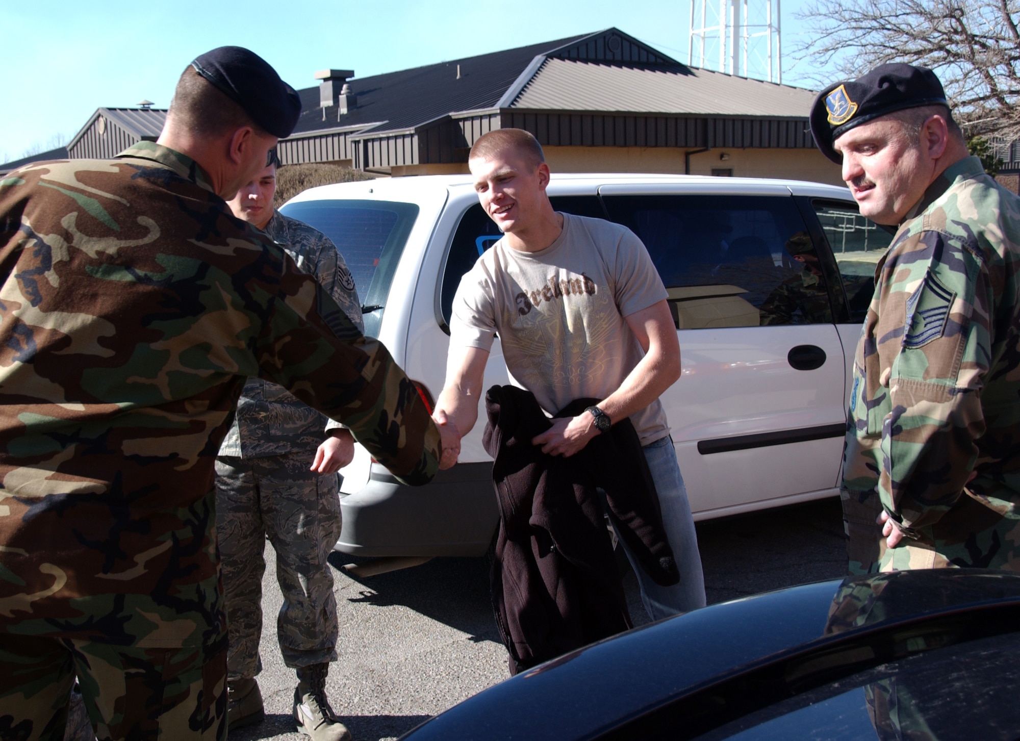 ALTUS AIR FORCE BASE, Okla. – Center, Capt. Jason Livingston, 97th Security Force Squadron, greets fellow 97 SFS Airmen upon his return from deployment to Southwest Asia Feb. 6. (U.S. Air Force photo/Senior Airman Clinton Atkins)